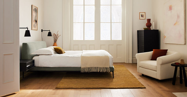 green bed in a large bedroom decorated bedroom. Link to upholstered bed