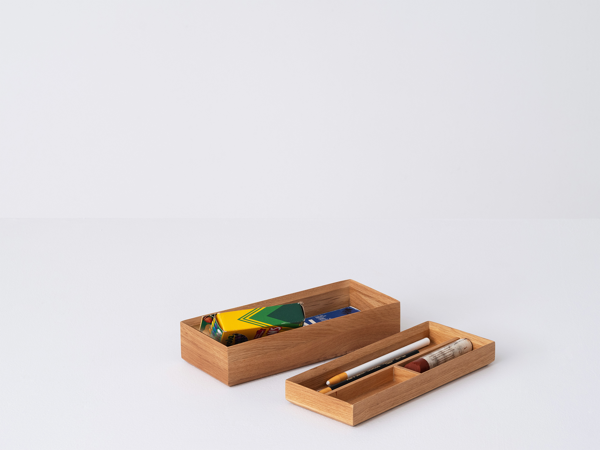 Angled view of the small Draft Pencil Box in oak unstacked