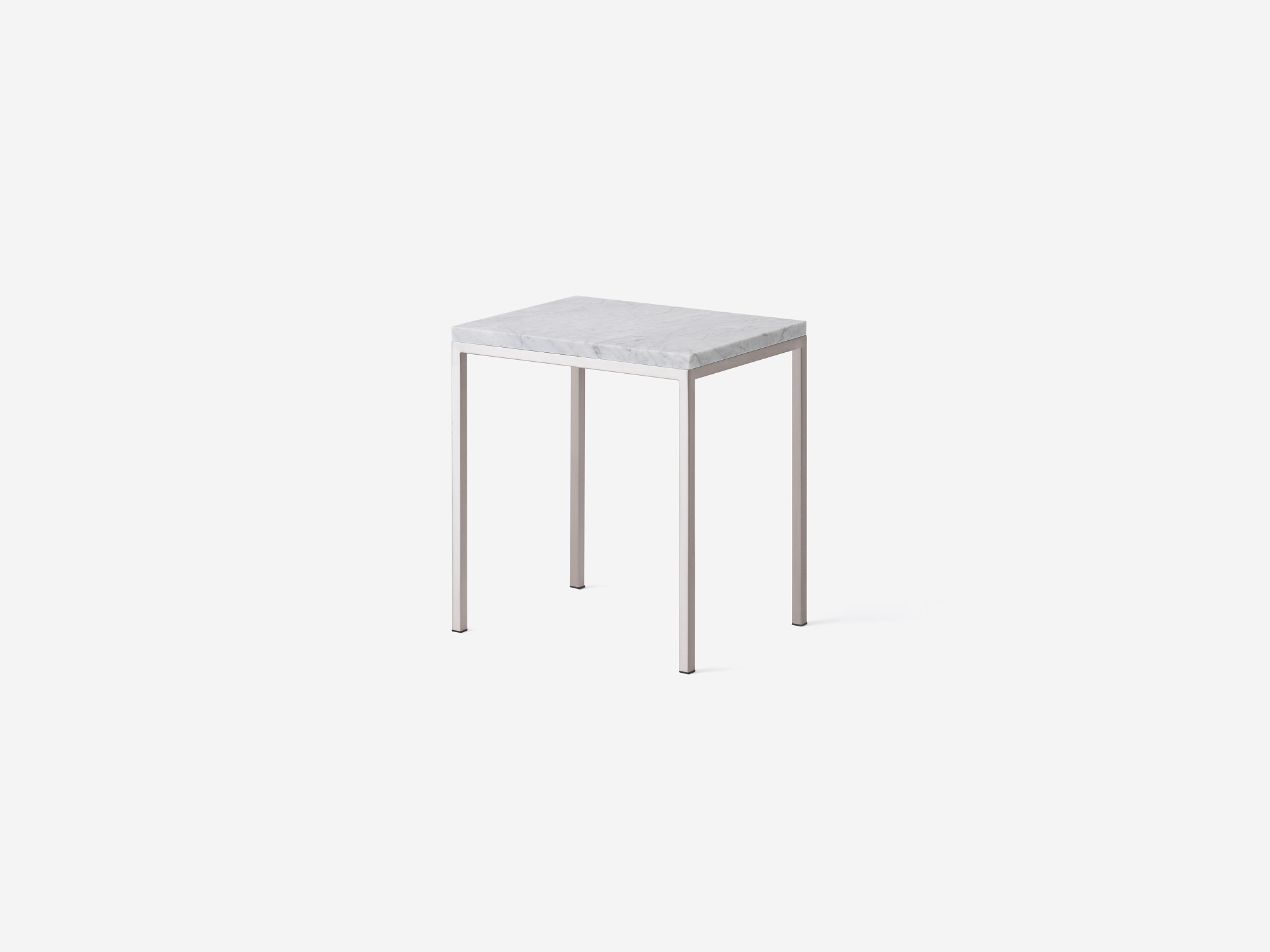 Front angle view of white marble top and stainless steel end table