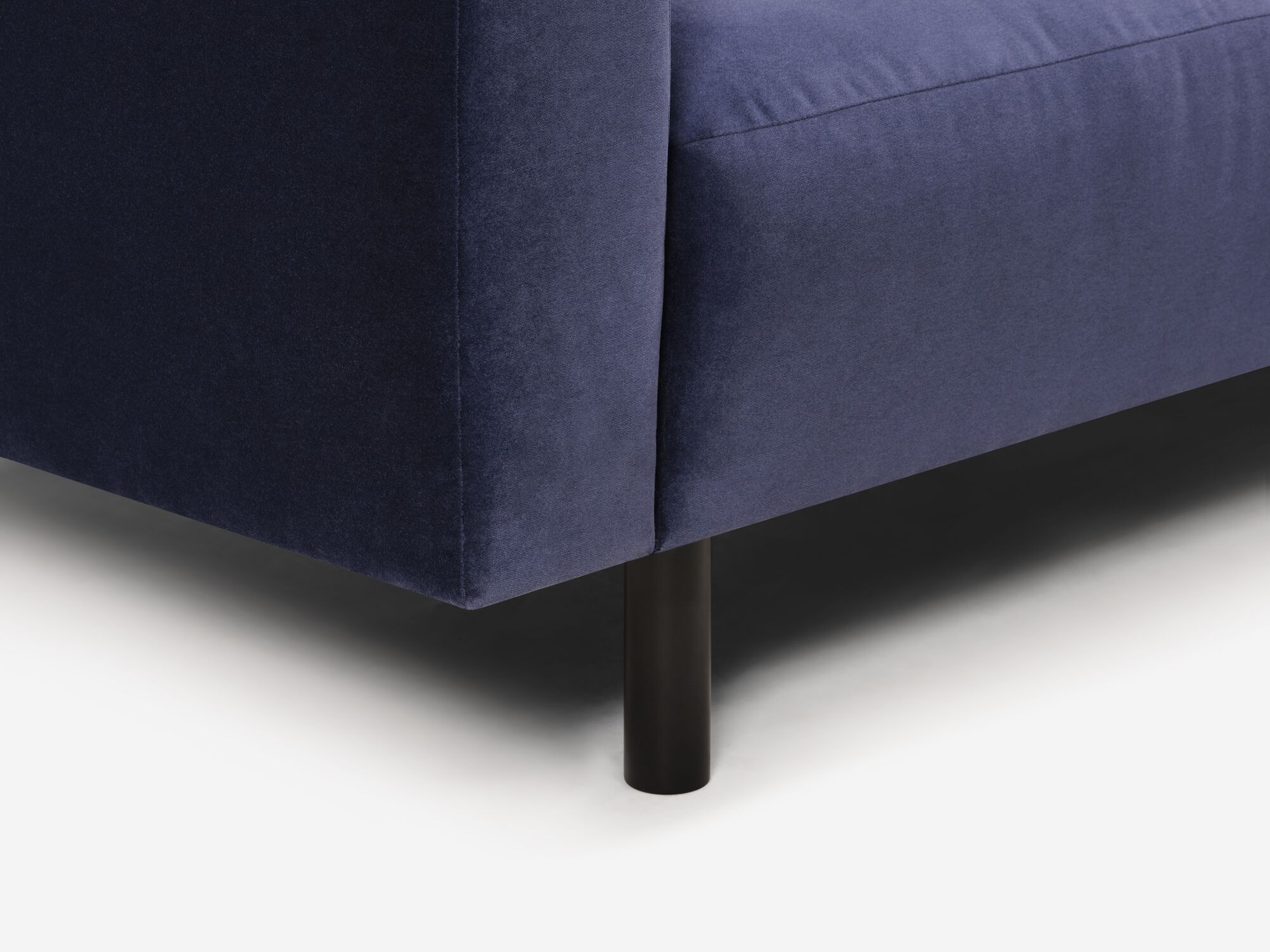 Blue velvet sofa leg detail view