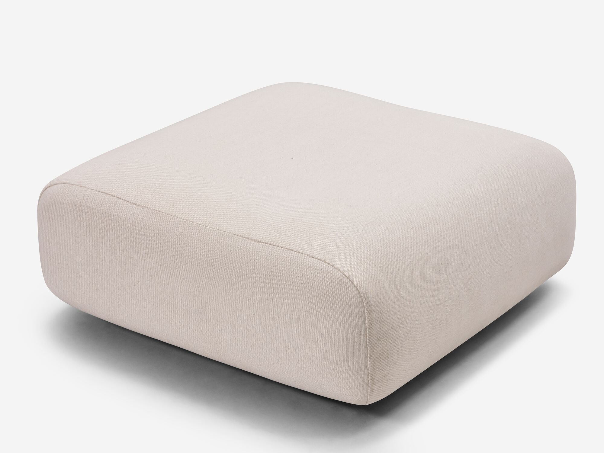 Detail view of rounded beige ottoman