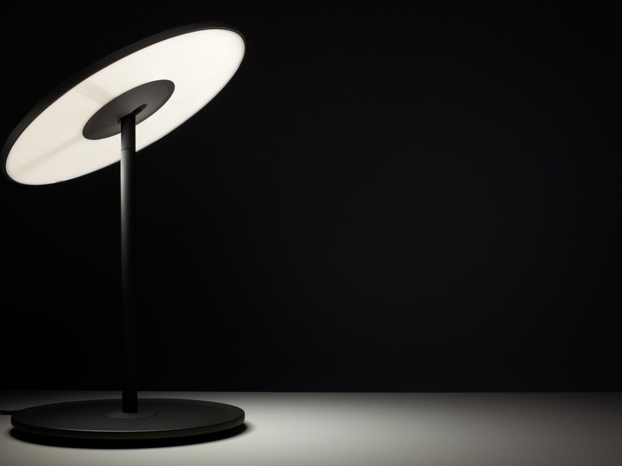 Circa table lamp in dark room with light on