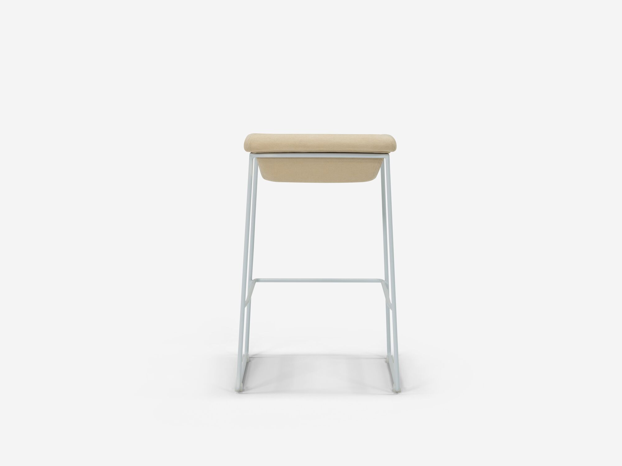 Back view of counter stool with beige seat and white legs