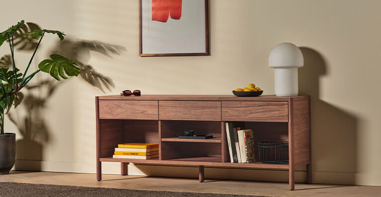 eq3s monarch walnut media unit is shown against a beige wall. Link to media storage category