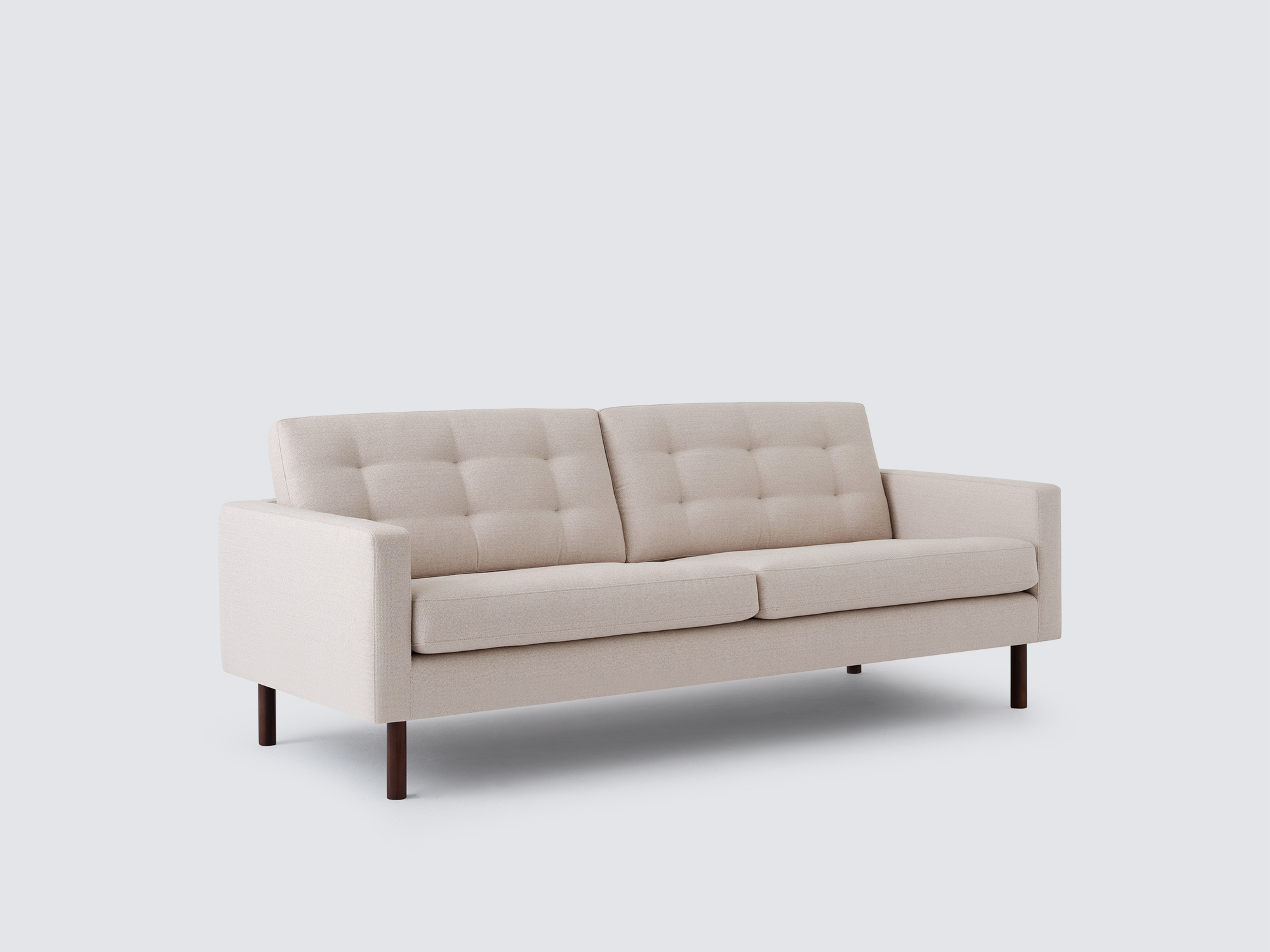 Angled view of the Joan modern sofa upholstered in beige fabric