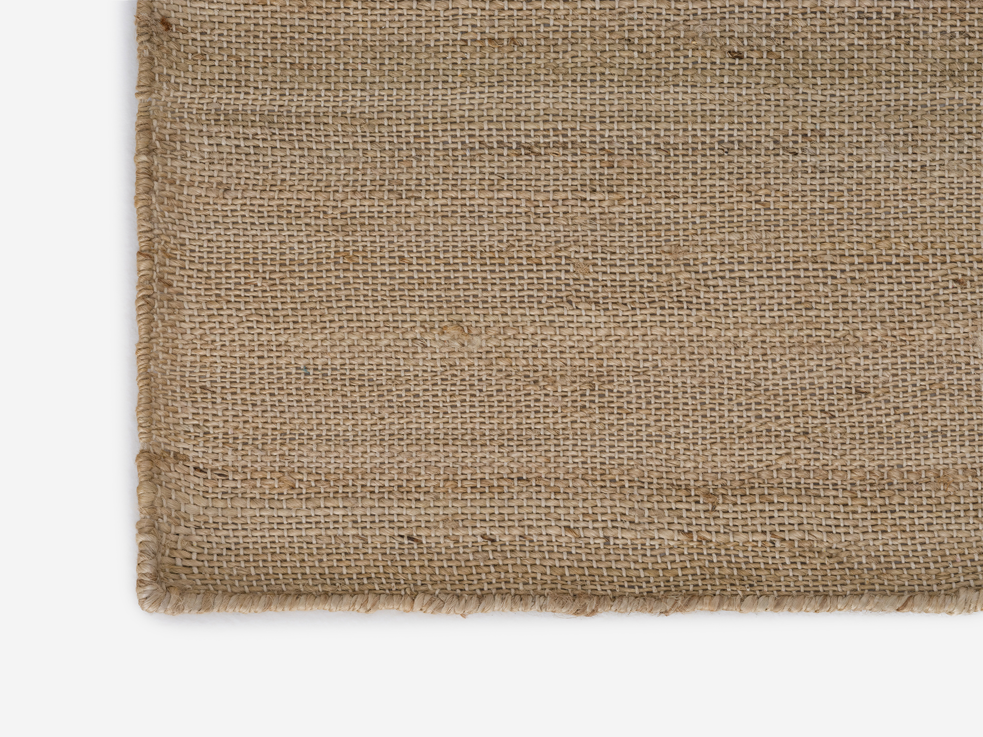 Corner detail view of hand woven jute large rug