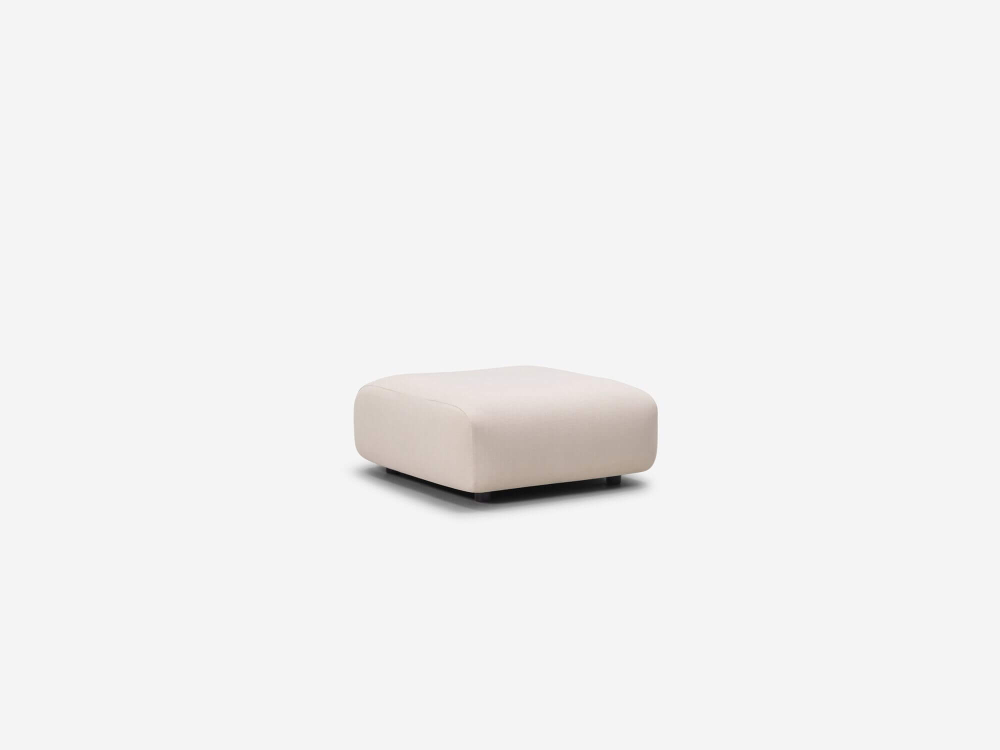 Rounded beige ottoman corner view
