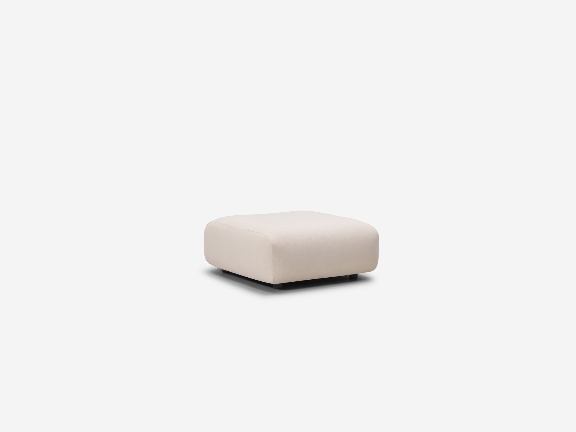 Rounded beige ottoman corner view