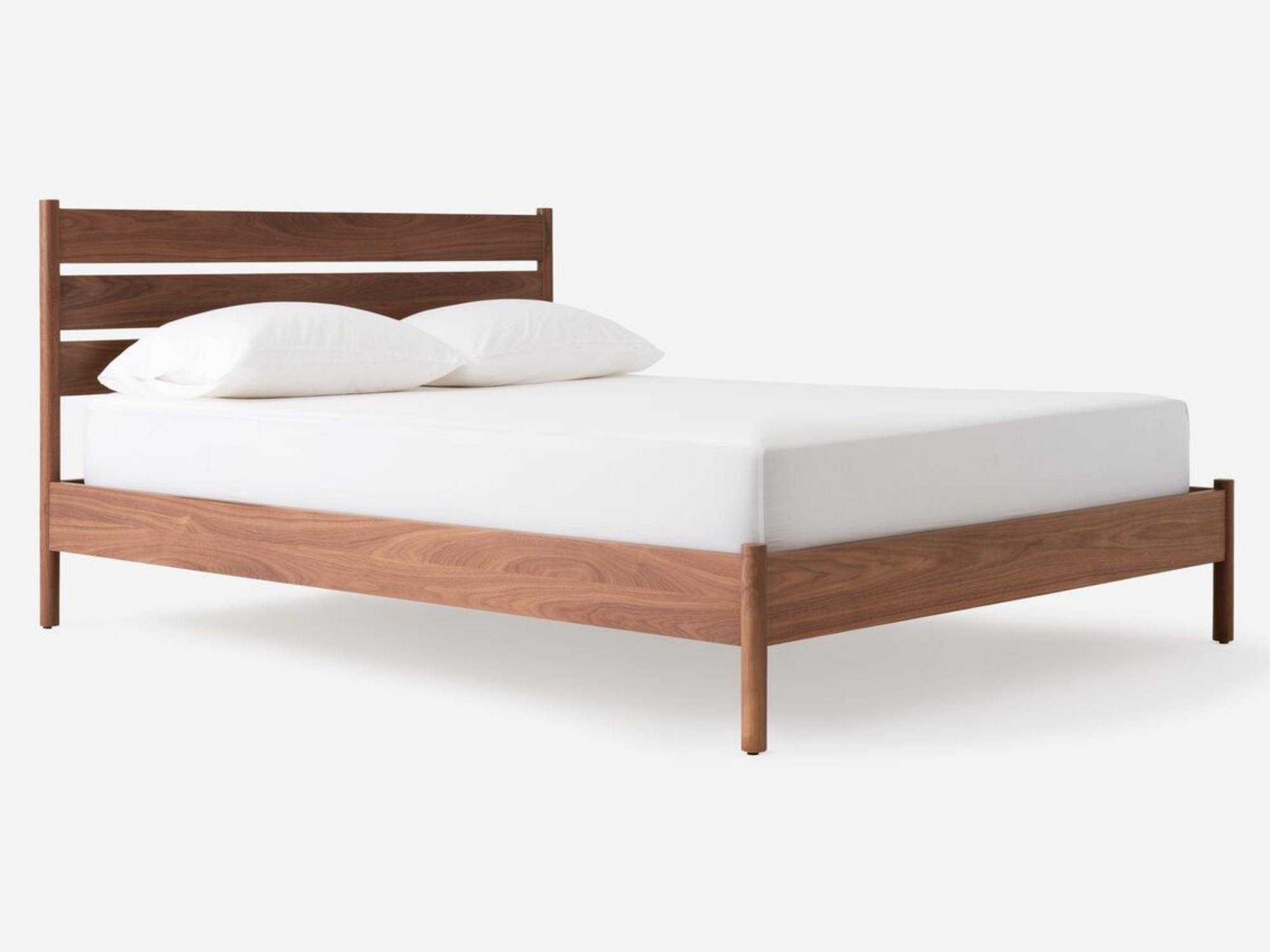 Angled view of our modern platform bed Monarch in walnut