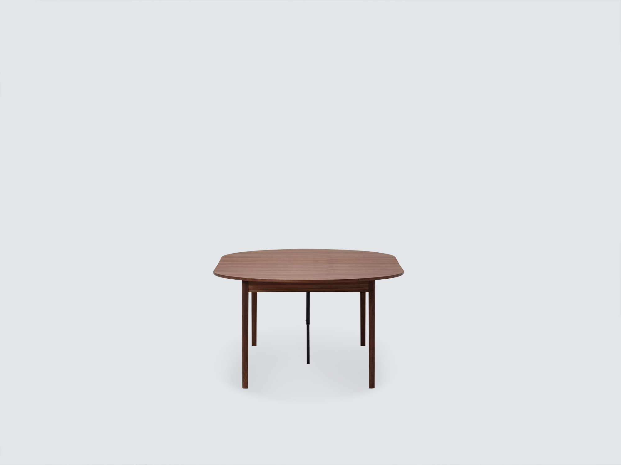 Front view of the small expanded Ease Expandable Dining Table in walnut