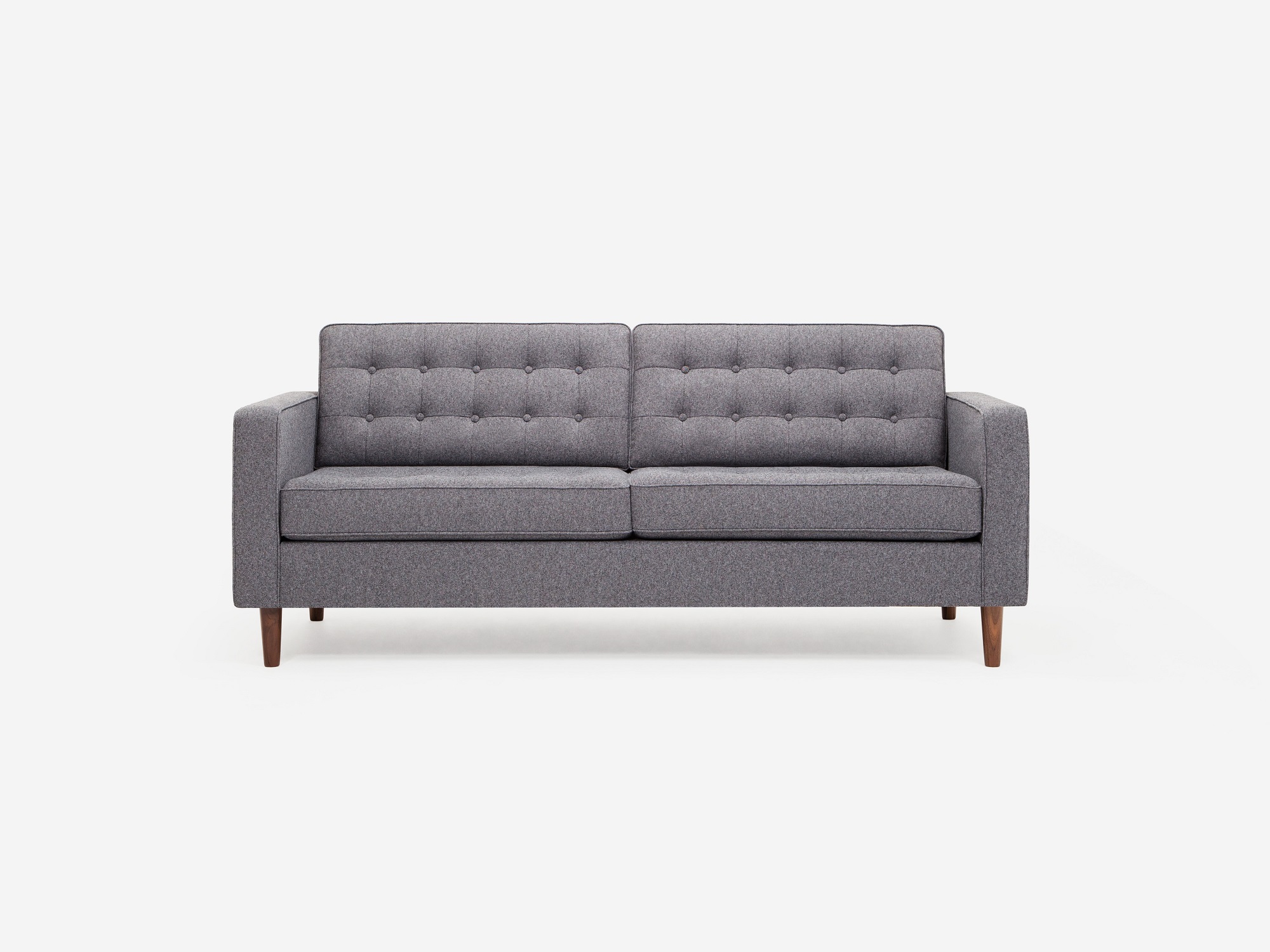 Front view of grey tufted apartment sofa with walnut legs