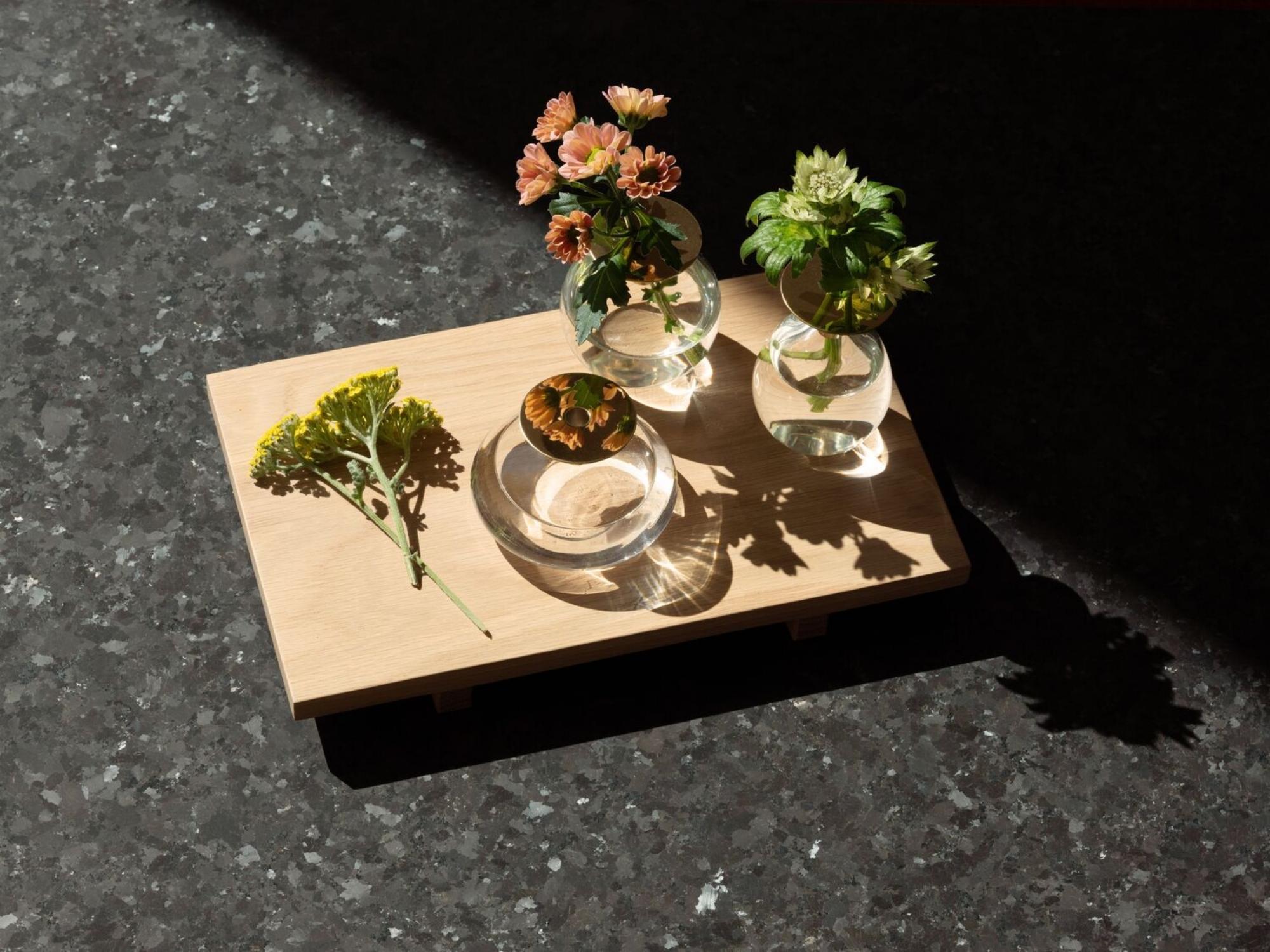 Solid oak tray with small glass flower vases on it