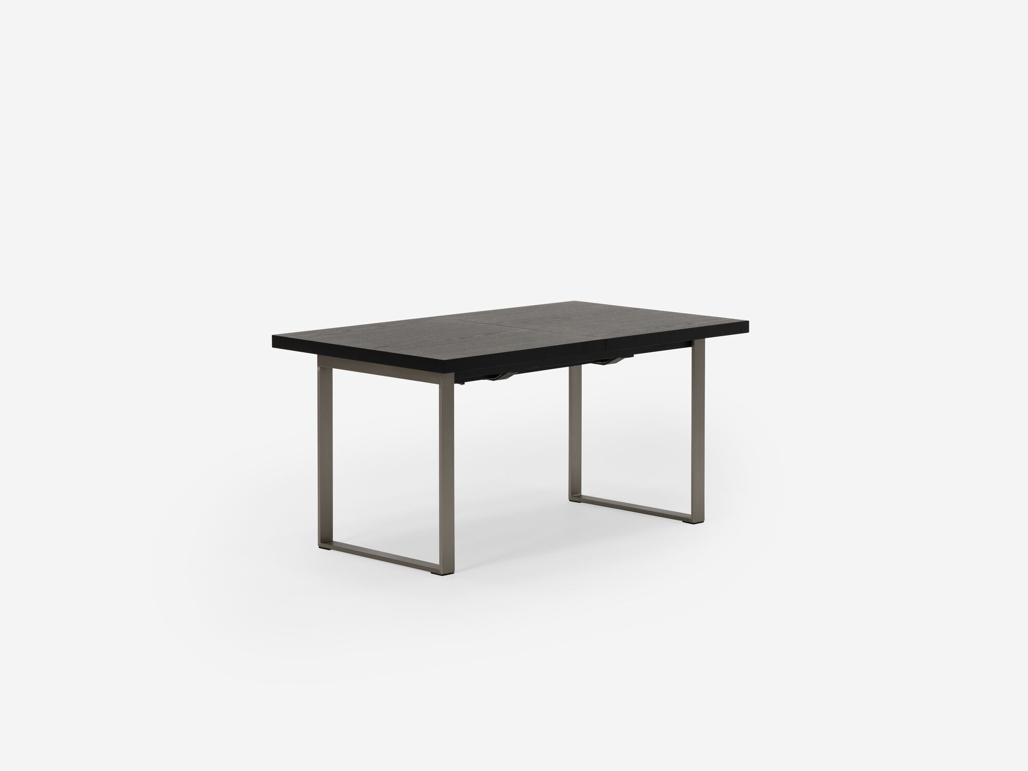 Corner view of expandable dining table with stainless steel legs and black top