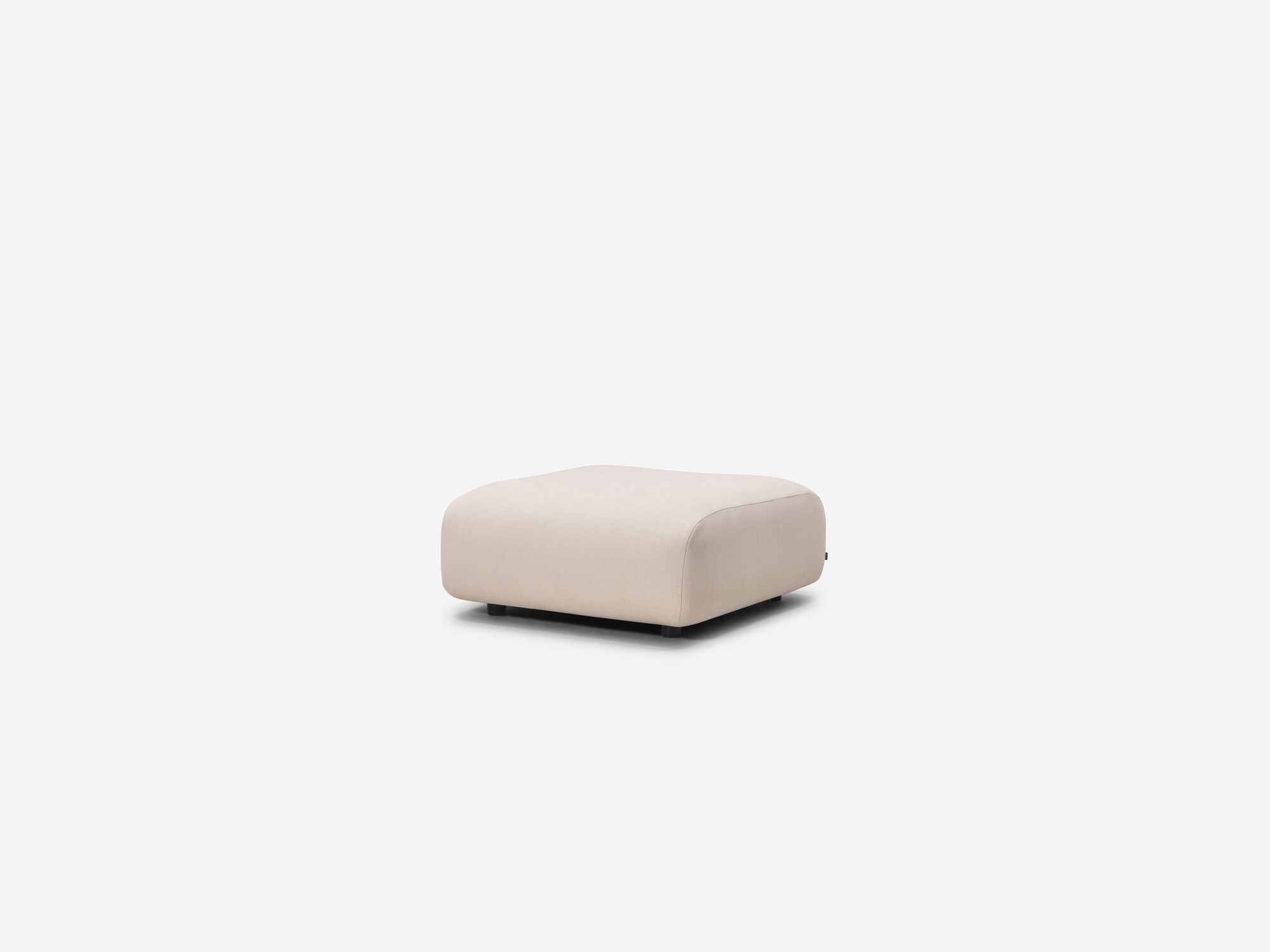 Rounded beige ottoman angle view