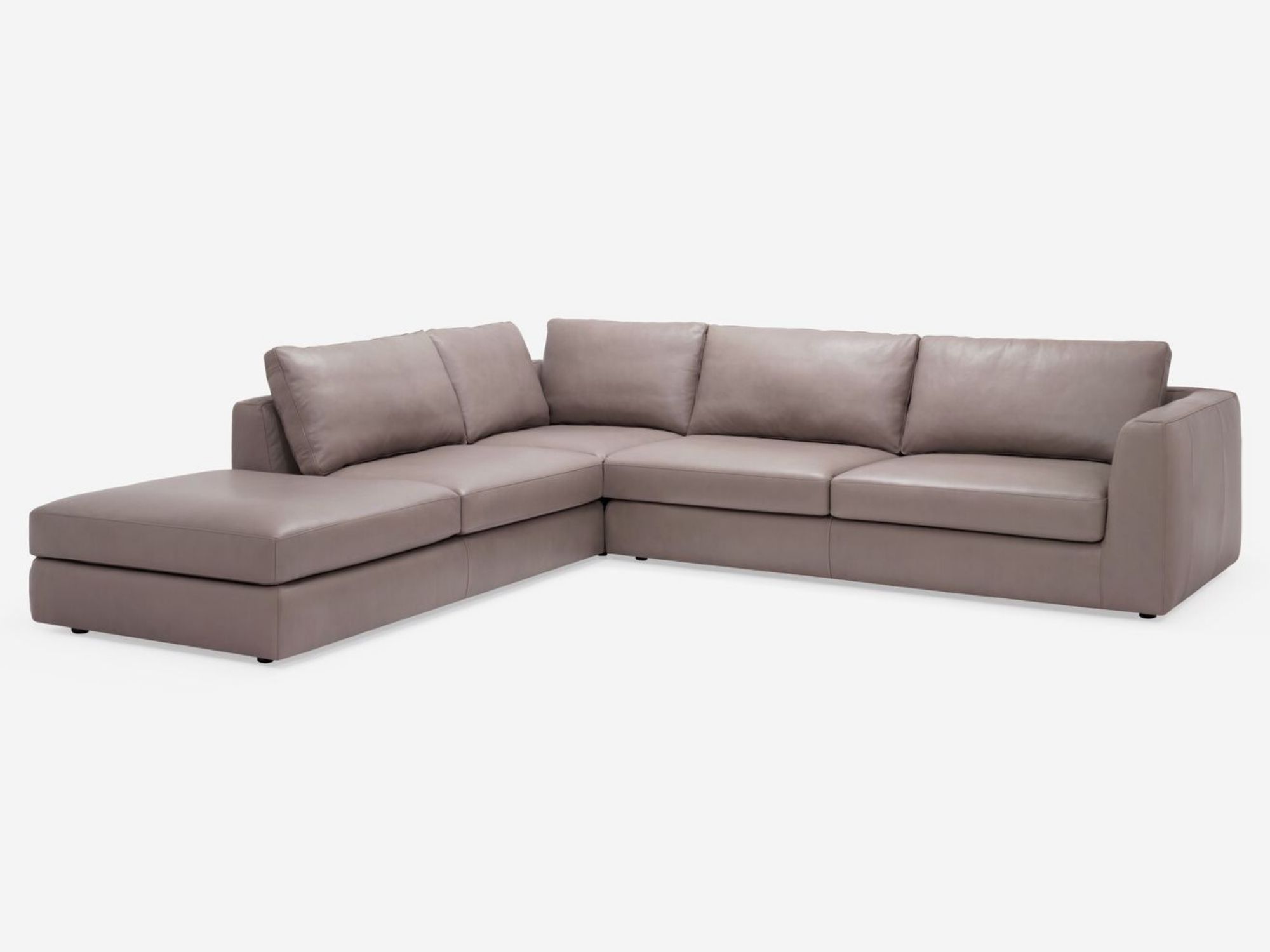 Front view of the modern sectional couch in beige leather with left hand chaise