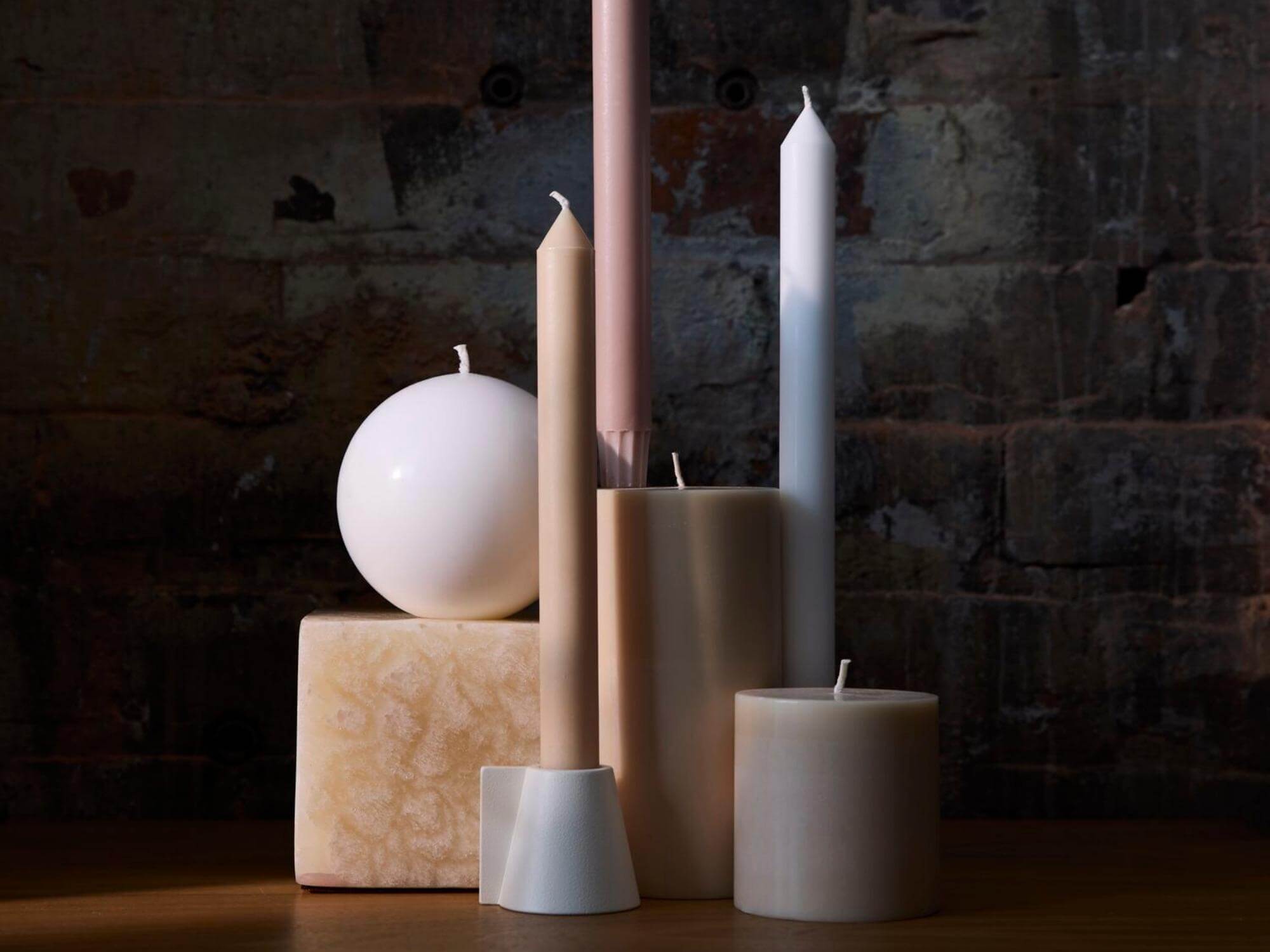 Angled white candleholder with multiple decorative candles