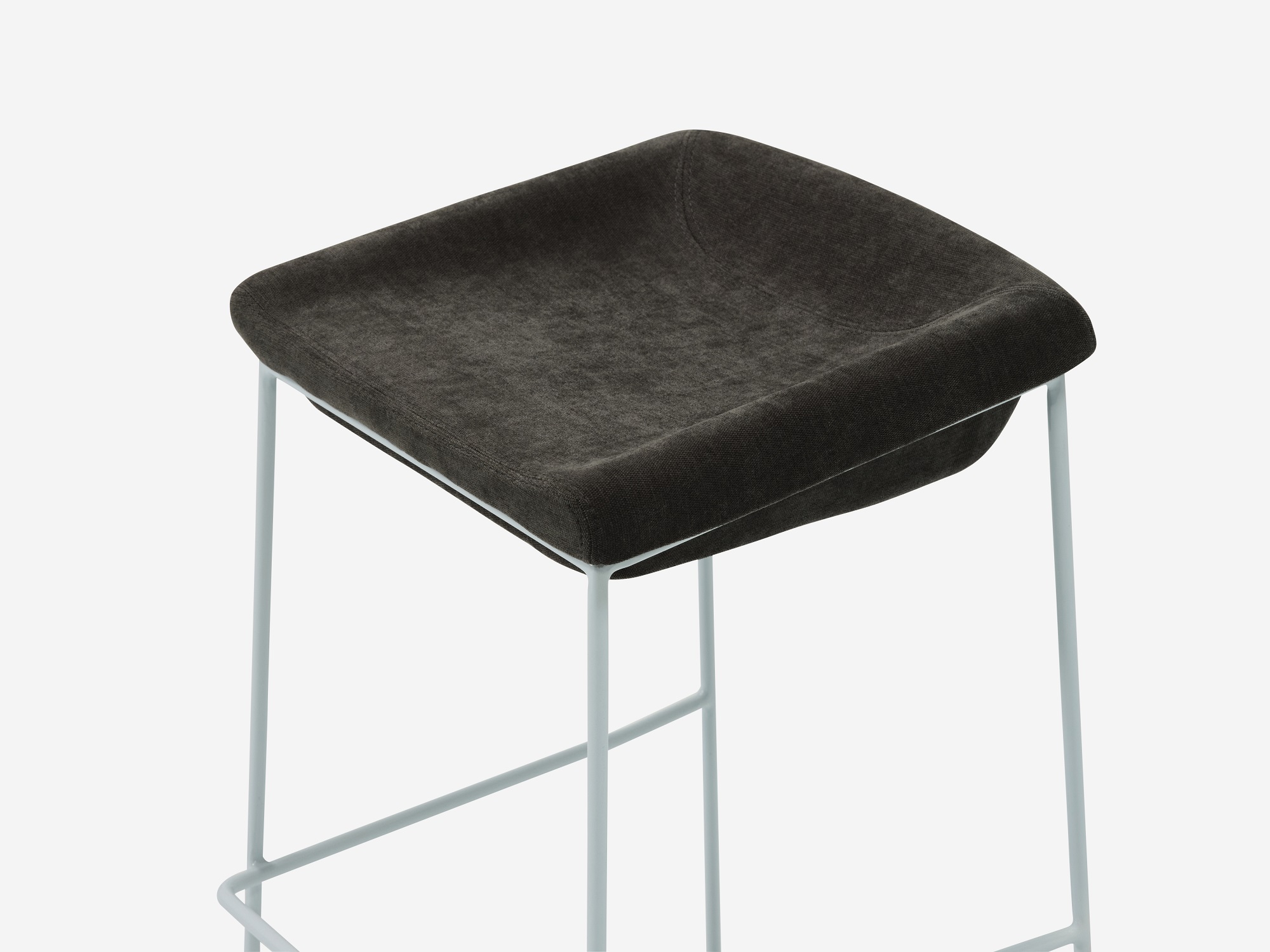 Counter stool with black seat and white legs detail view