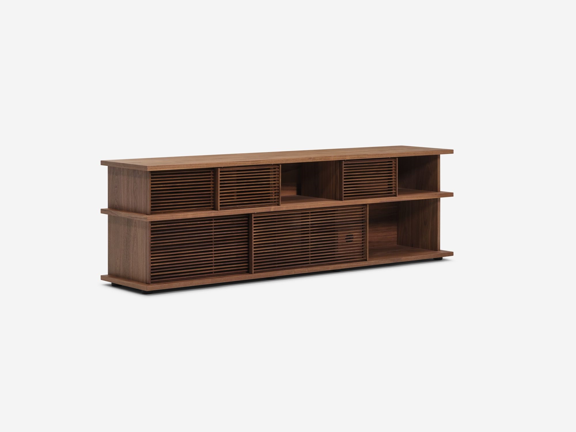 Angled view of the Plank tall modern media console in walnut with open drawers and slats