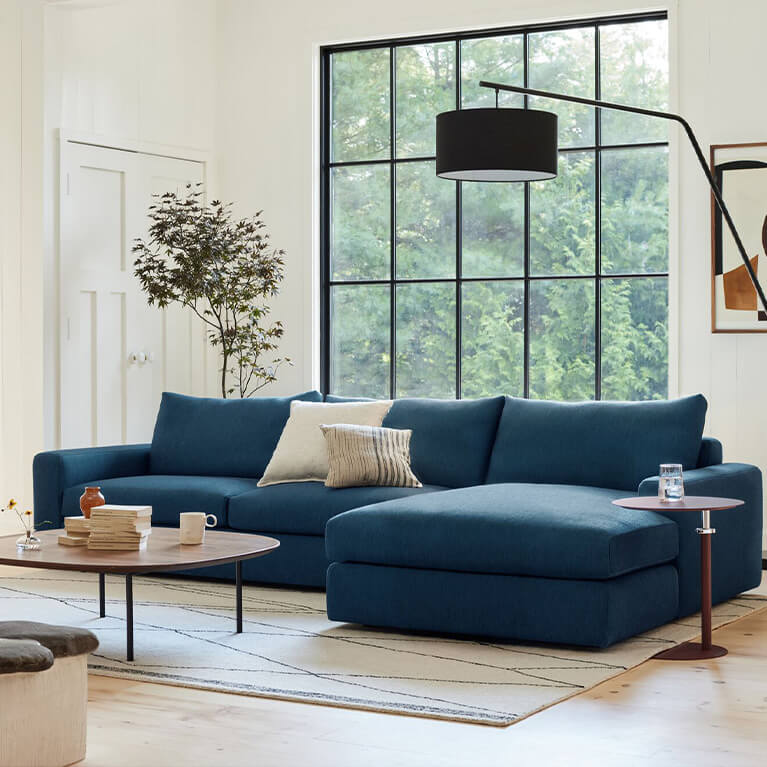 Blue sectional sofa is shown in a living room. Link to cello collection search page