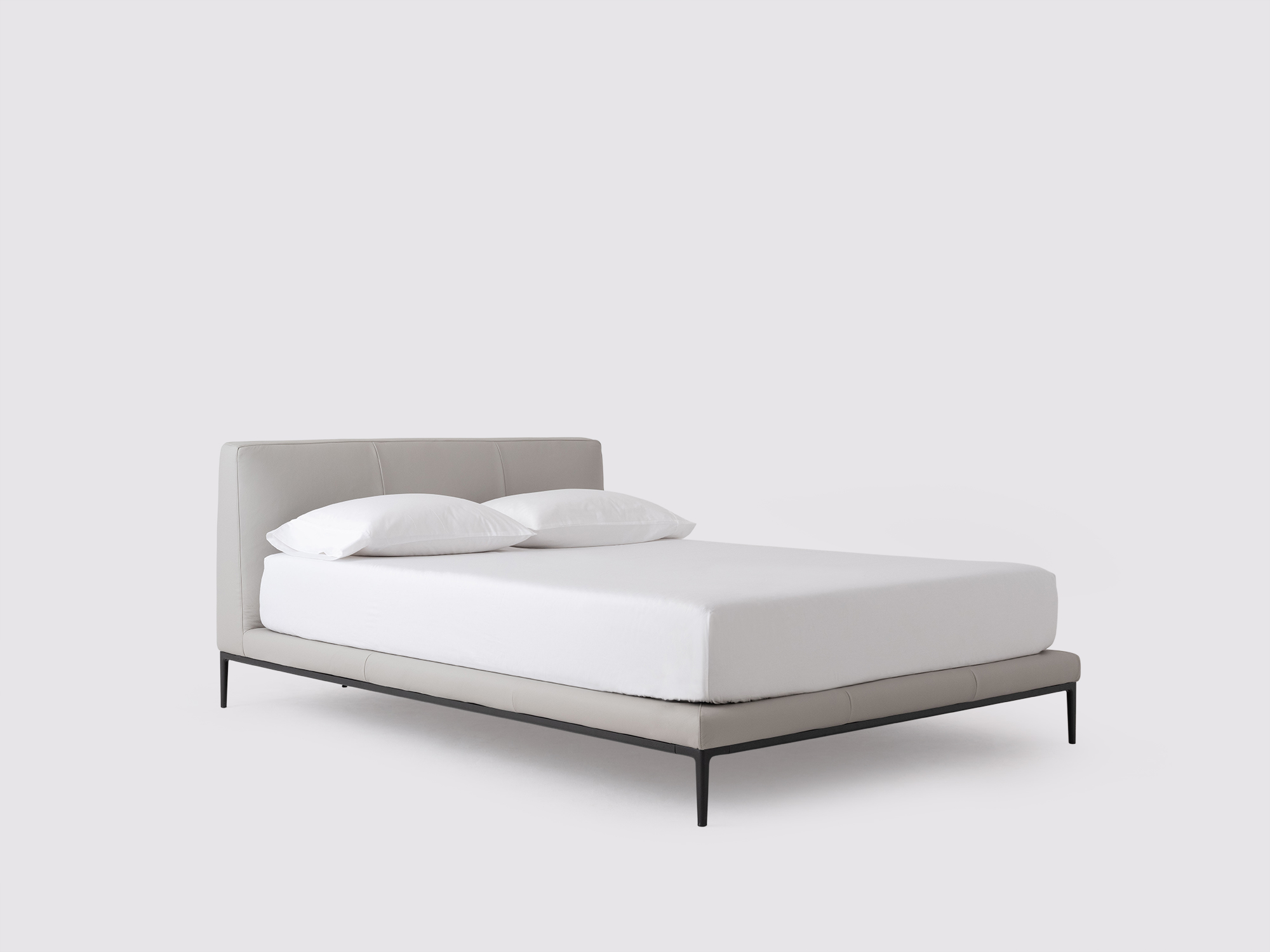 Angled view of the Oma modern upholstered bed in grey leather