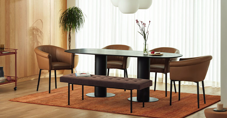 Large black oak dining table is displayed in a large dining room setting. Link to dining category