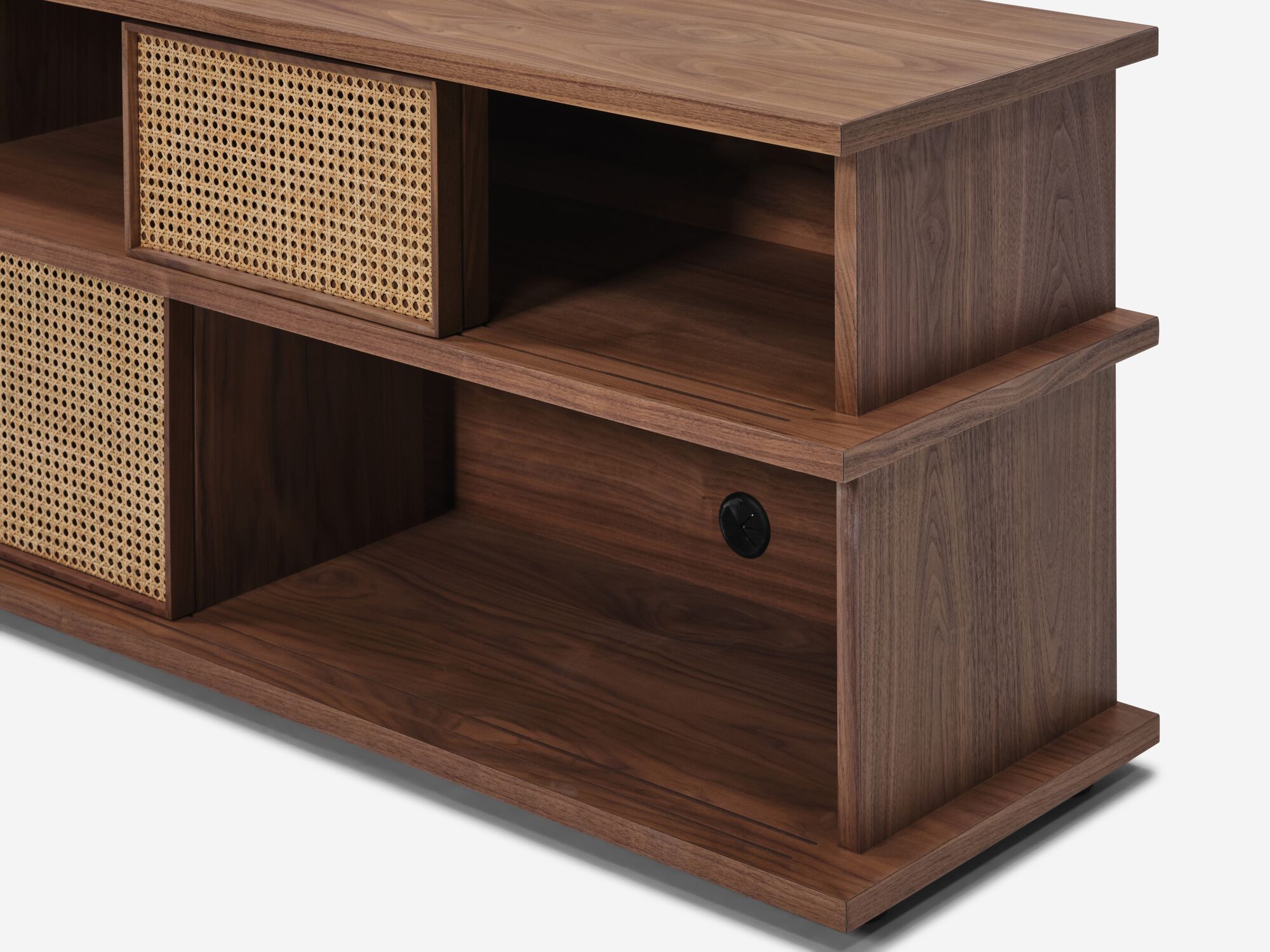 Detail view of tall walnut media unit with natural cane open doors