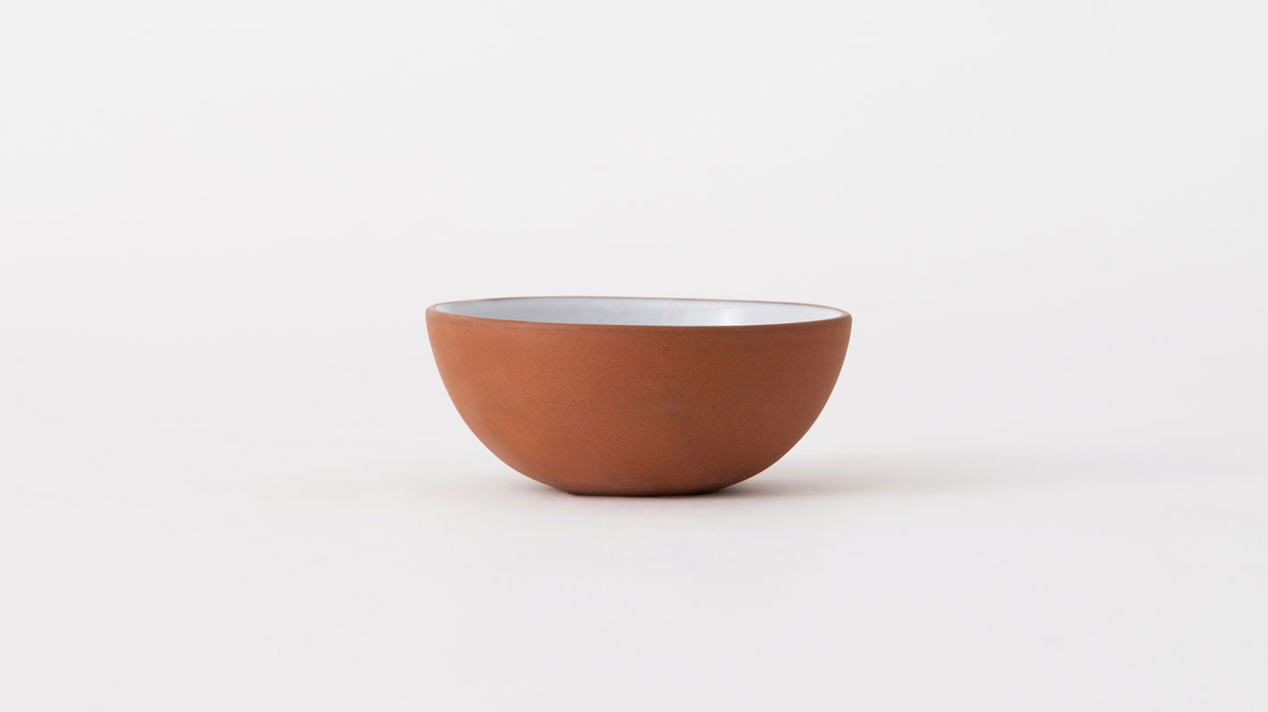 Small red and white stoneware bowl front view