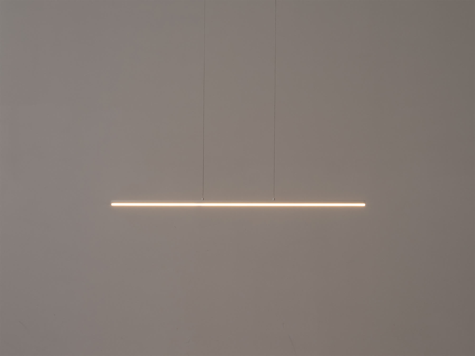 The small Slimline pendant light in white with light on