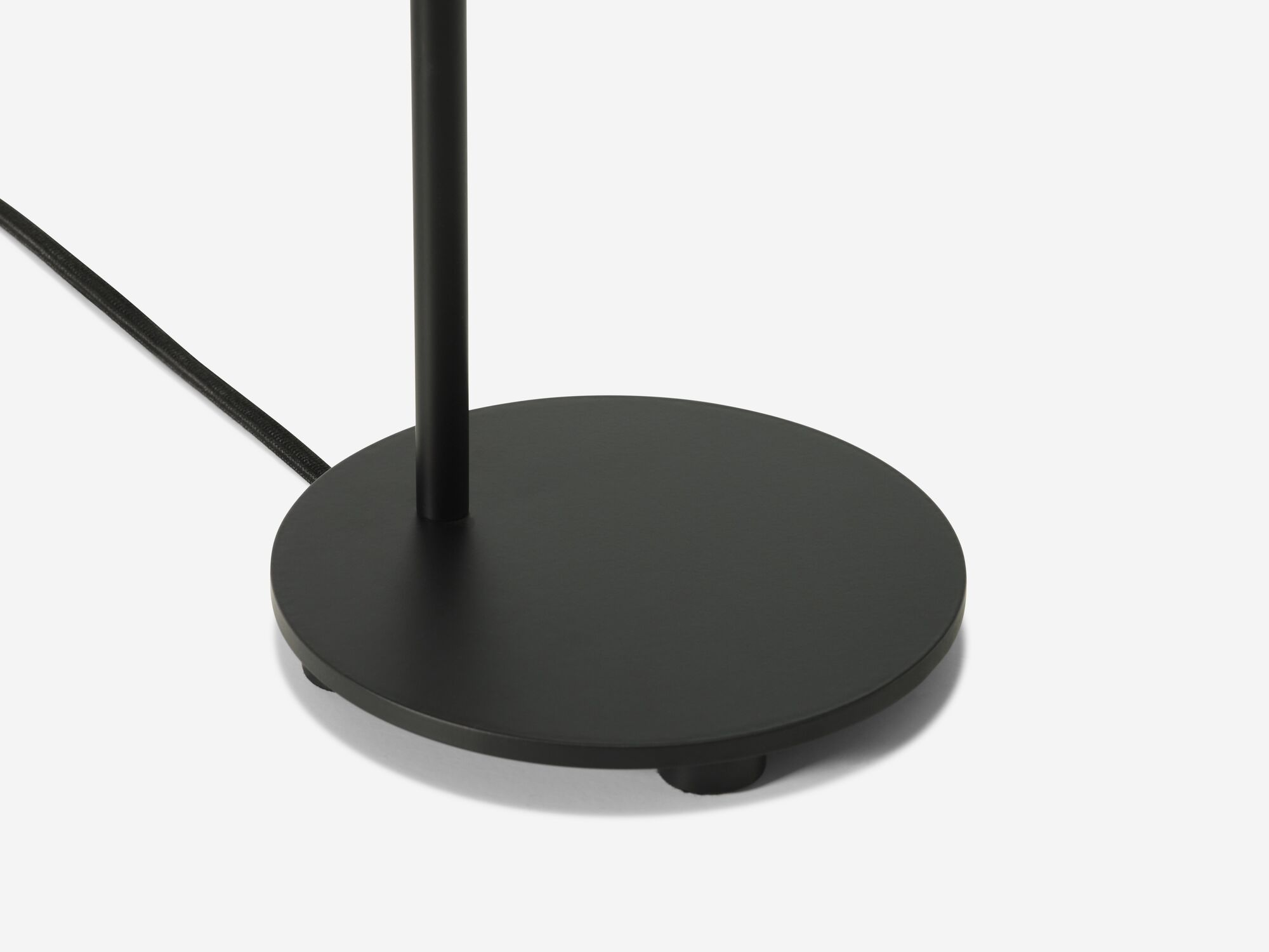 Detail base view of black curved table lamp