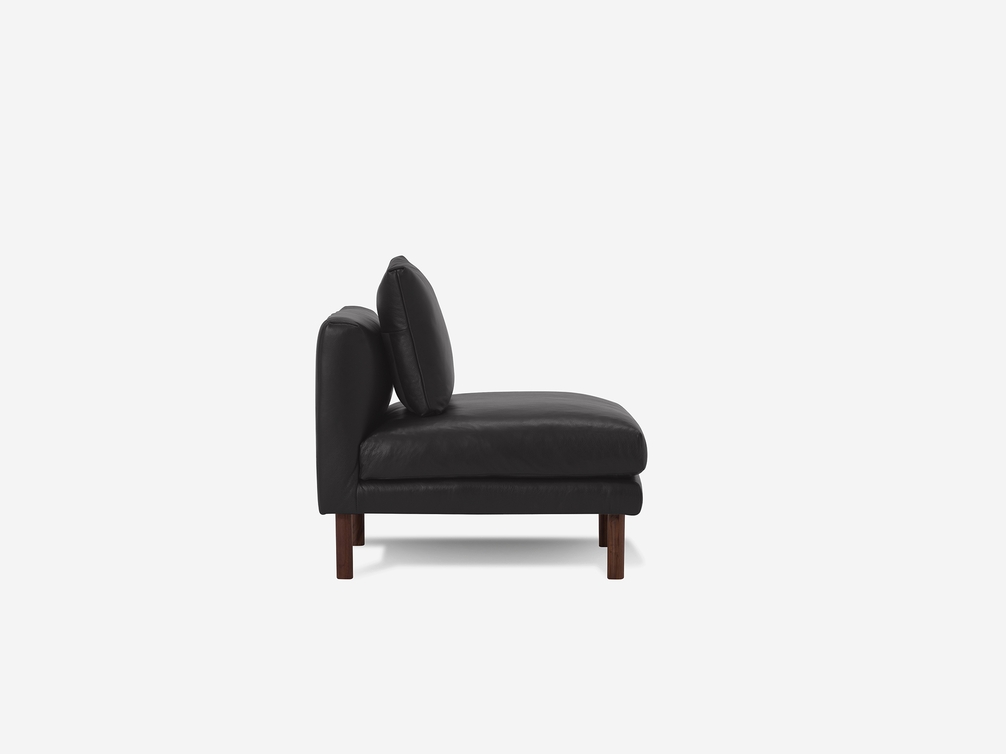 Side view of black leather armless chair with cushion