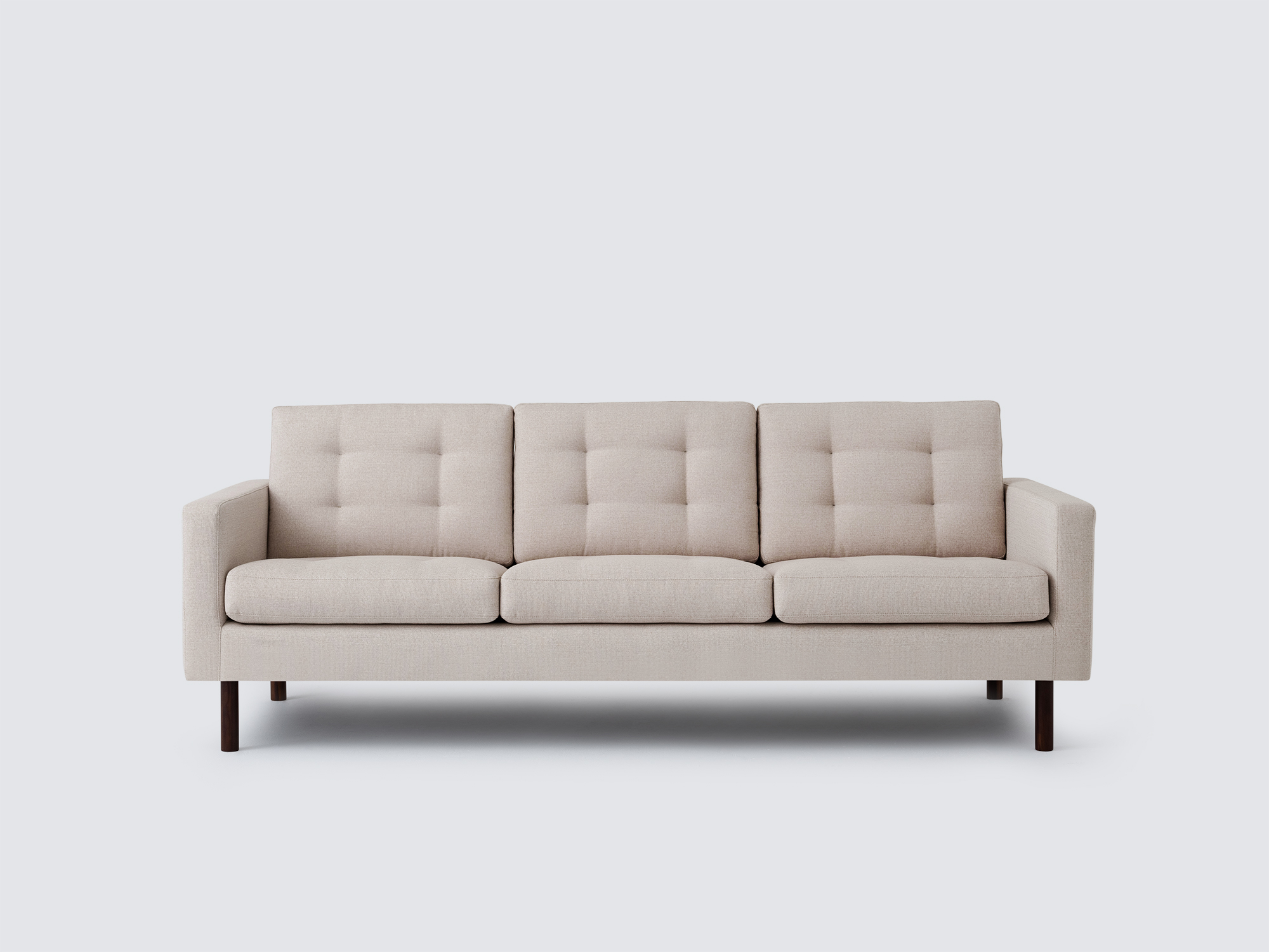 Front view of the Joan long modern sofa upholstered in beige fabric