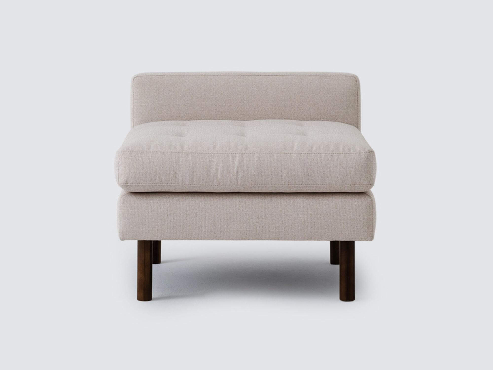 Front view of the Joan extended chair upholstered in beige fabric