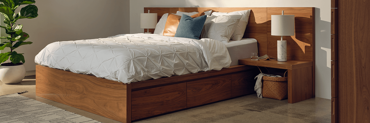 Walnut platform bedframe in modern bedroom with attached beside tables