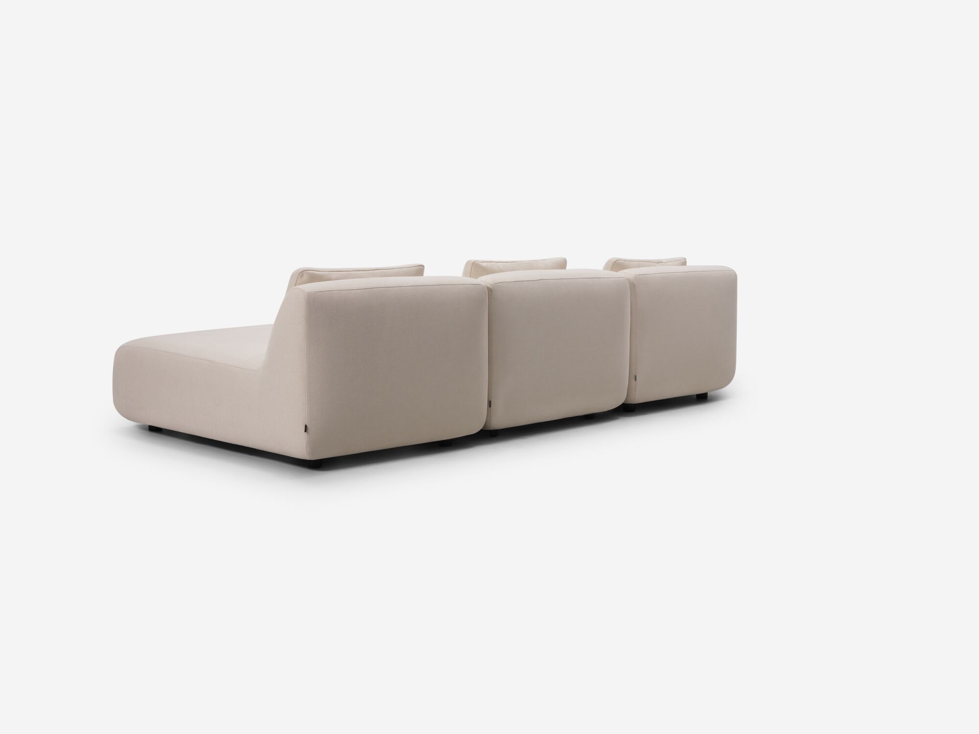 Beige armless sectional back angle view