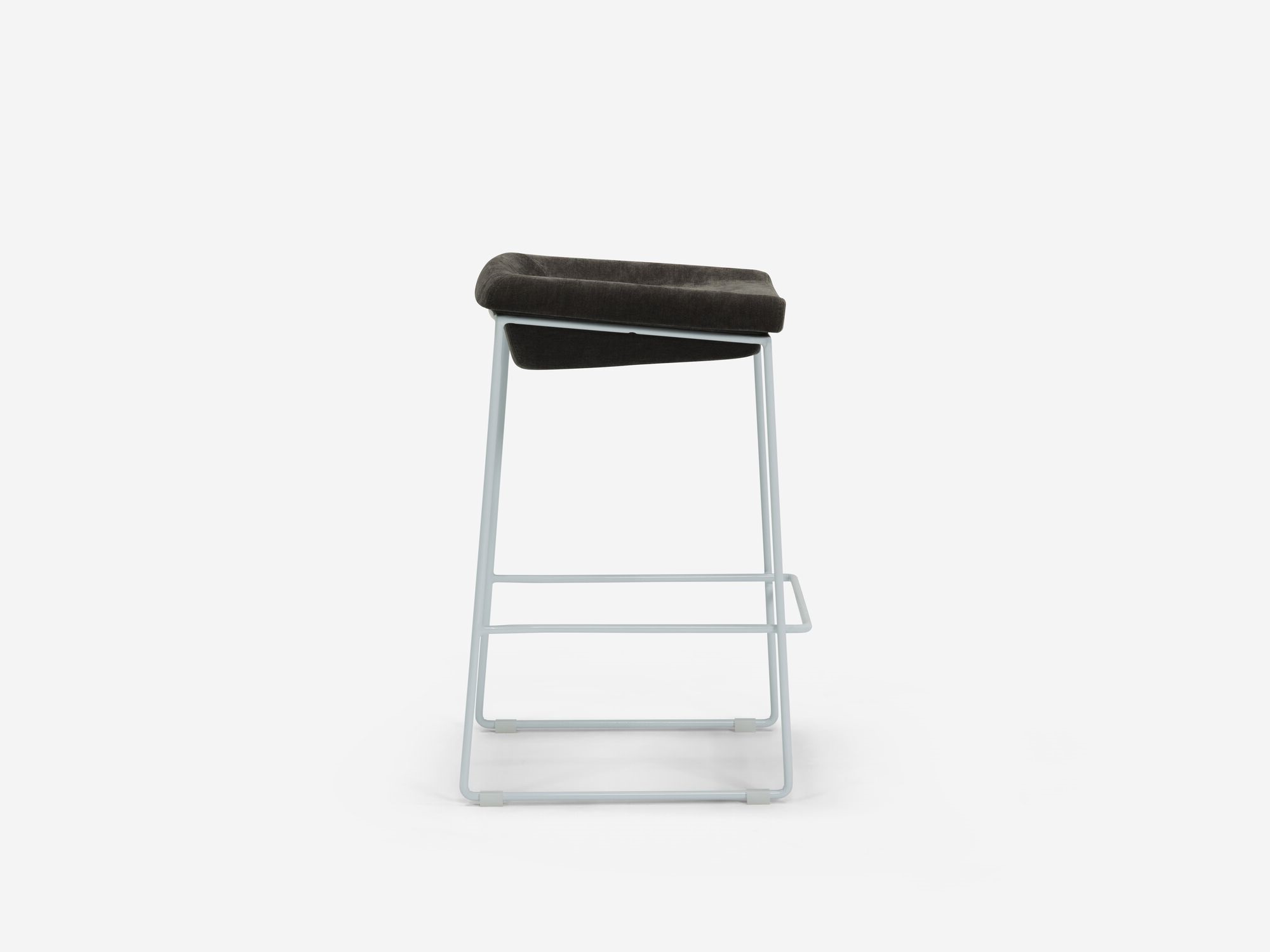 Side view of counter stool with black seat and white legs