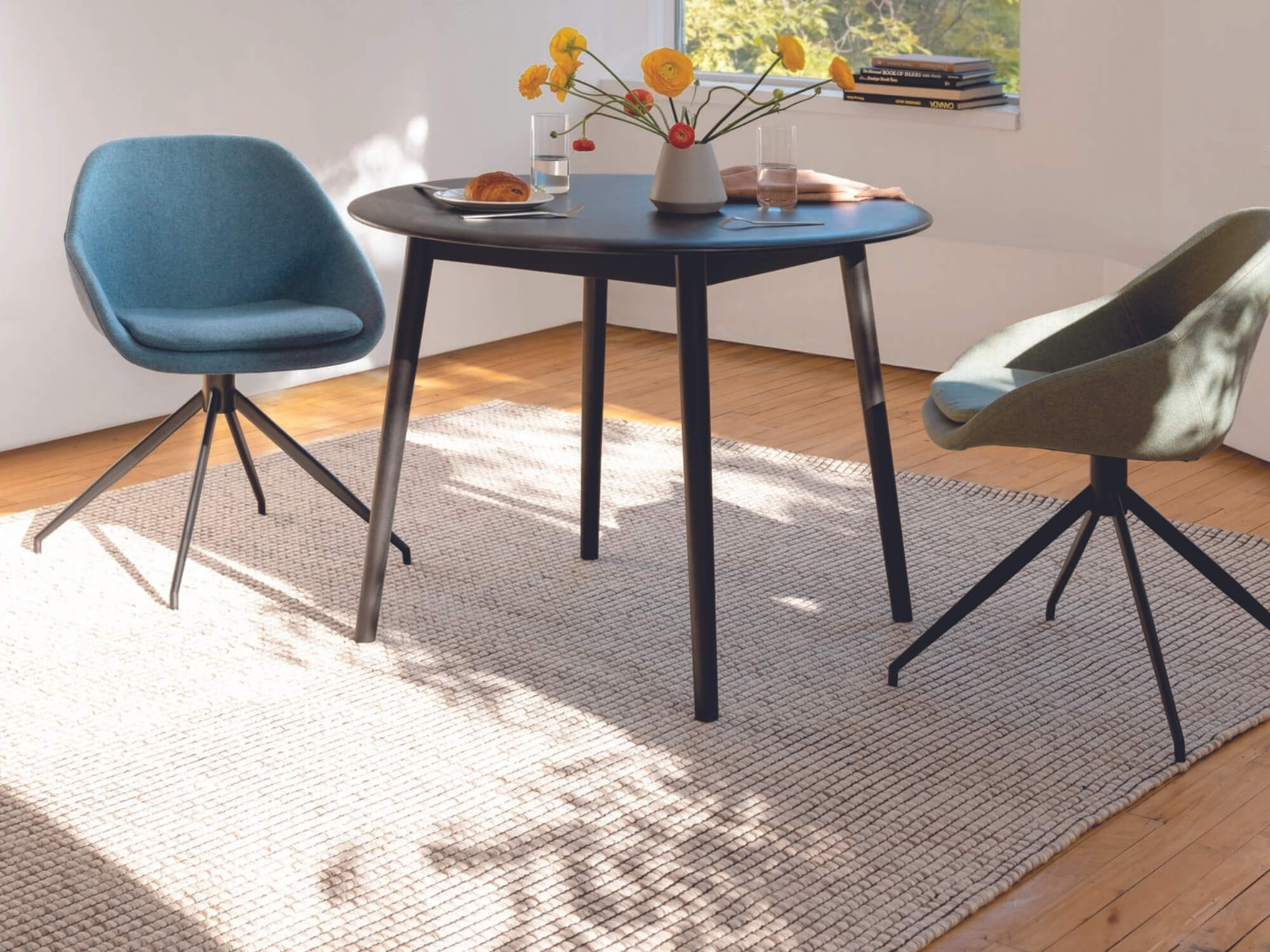 Beige rug under round dinette tables and chairs