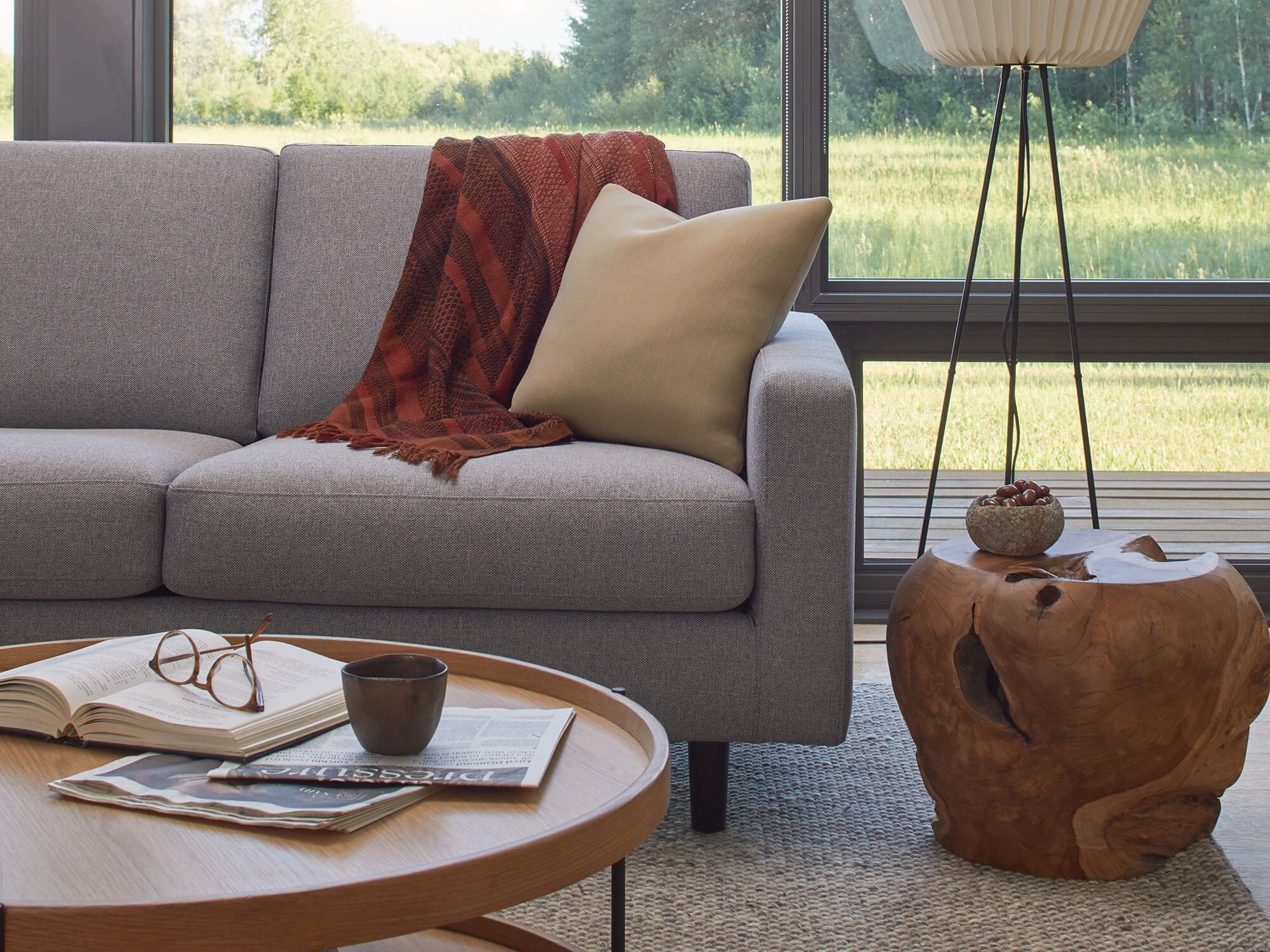 Solid teak stool next to a beige sofa in modern living room