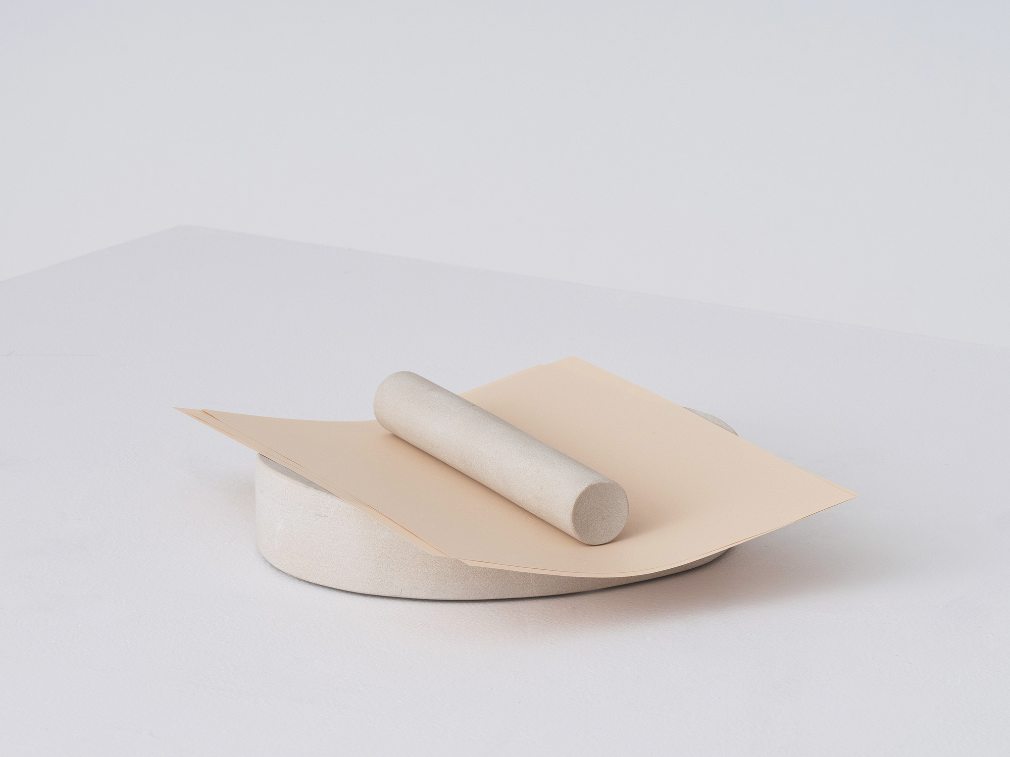 The Lithic paper holder in sandstone with paper on it