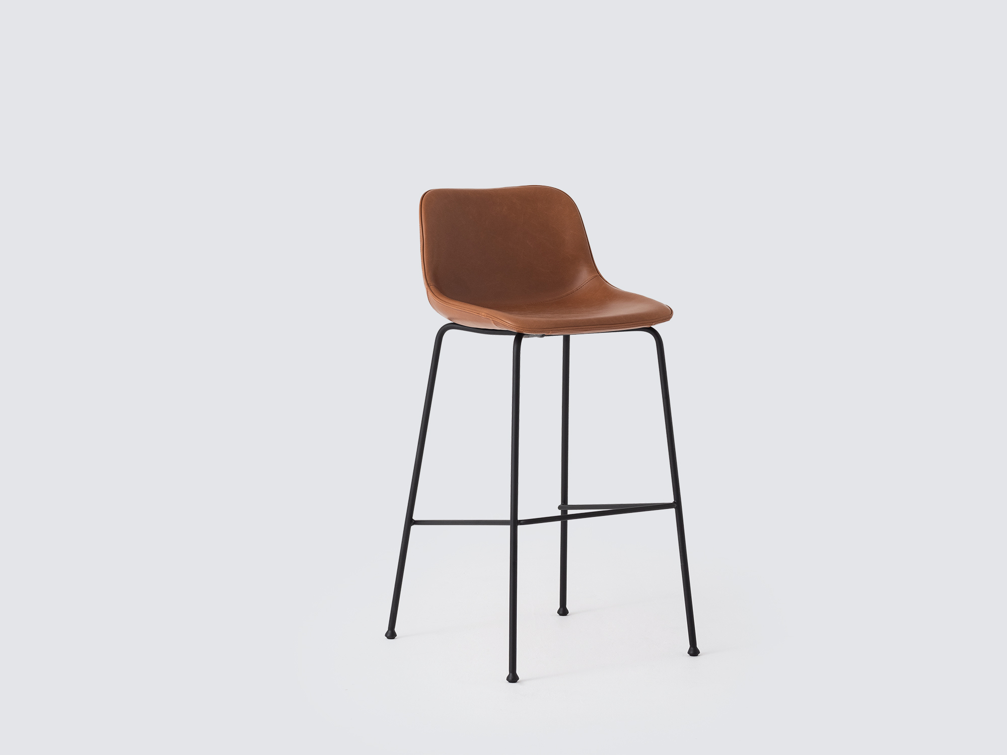 Angled view of the Oles counter height bat stool with brown leather seat