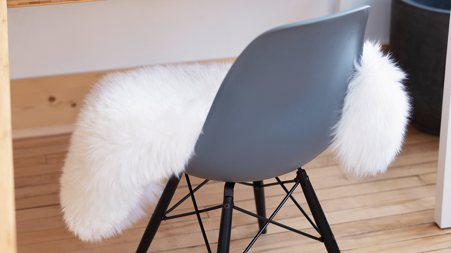 The New Zealand sheepskin rug on a herman miller molded plastic chair