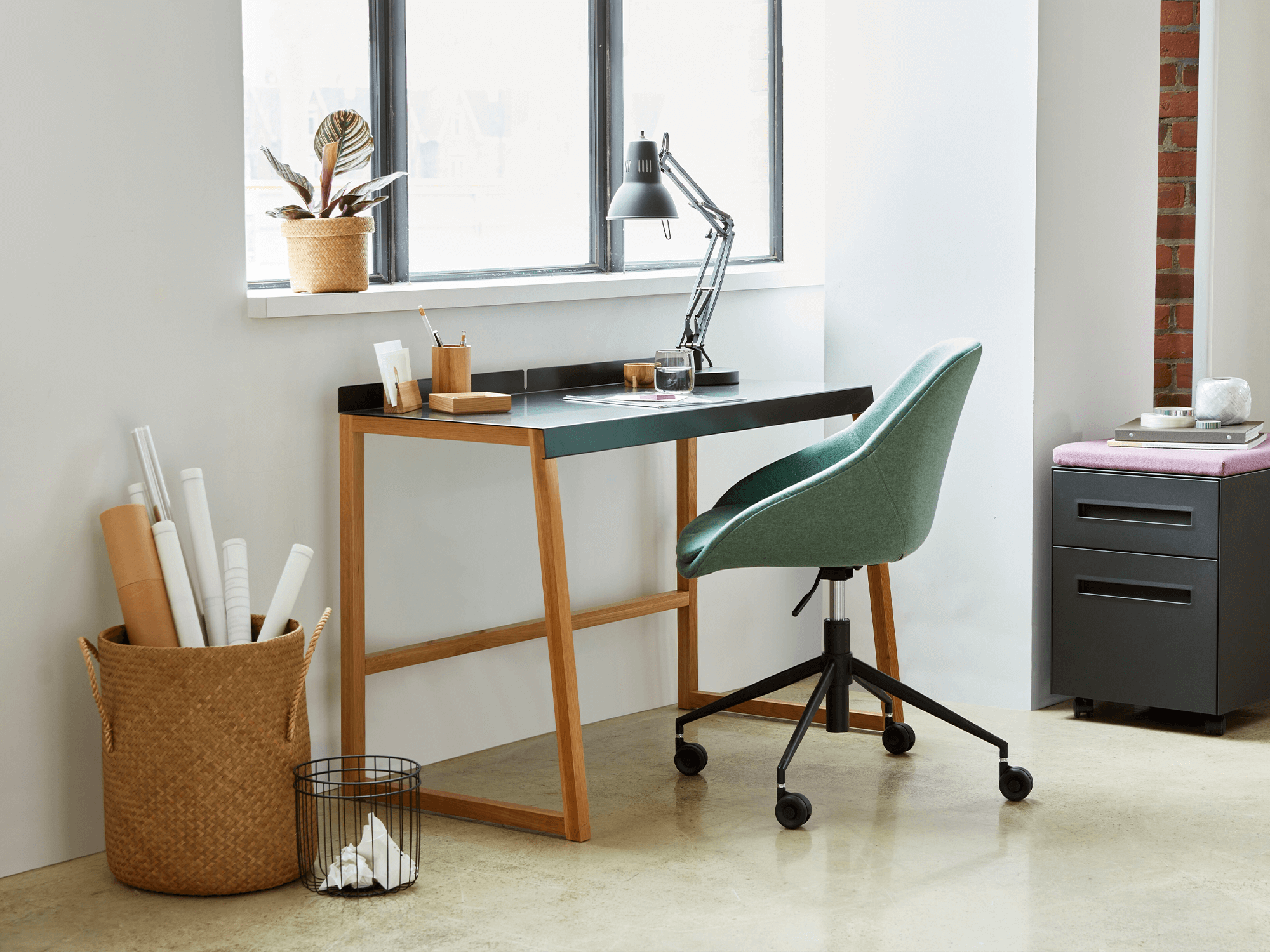 Black modern desk lamp sits on a desk in a home office