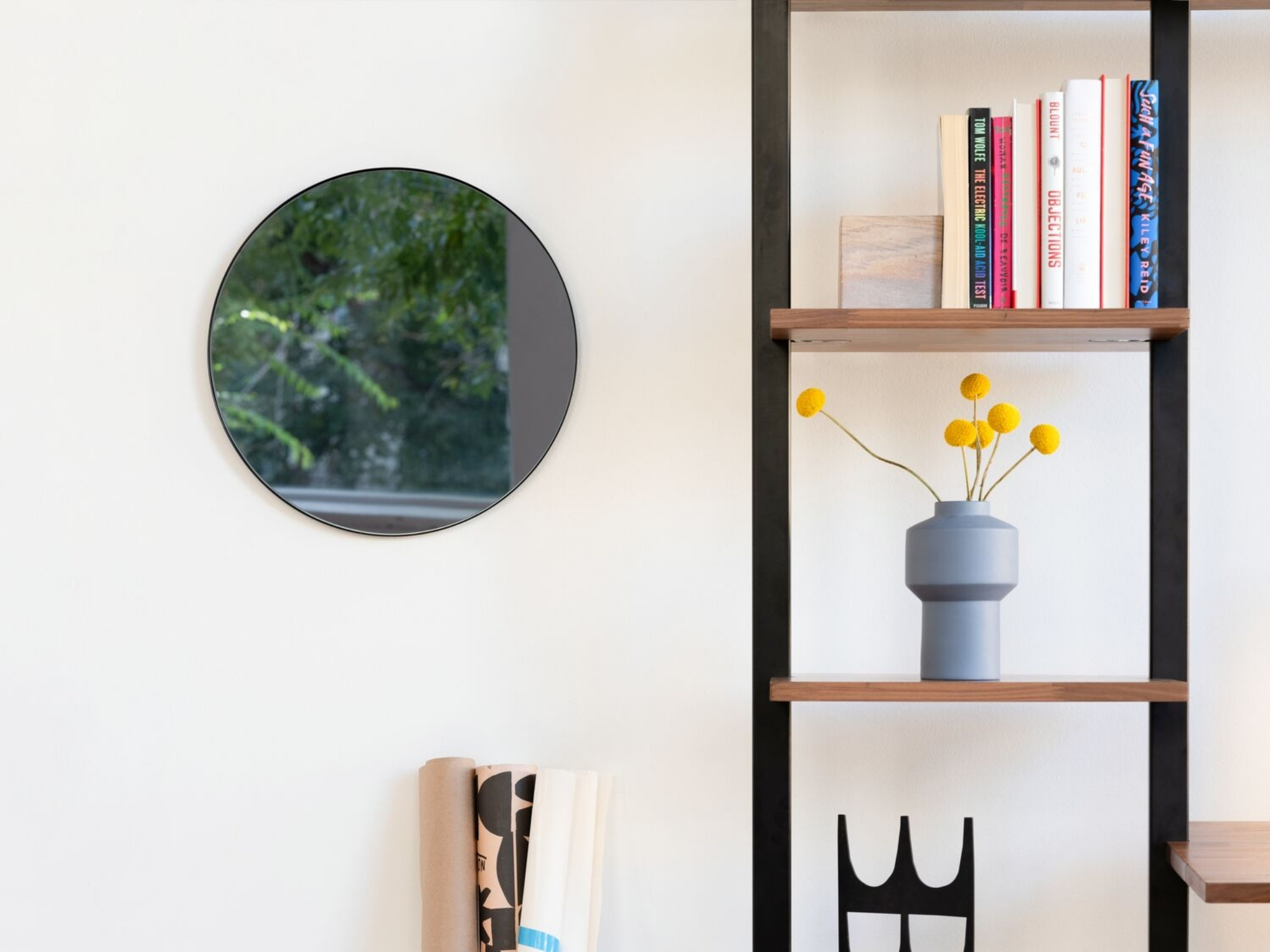 Modern blue flower vase on on open shelf bookcase