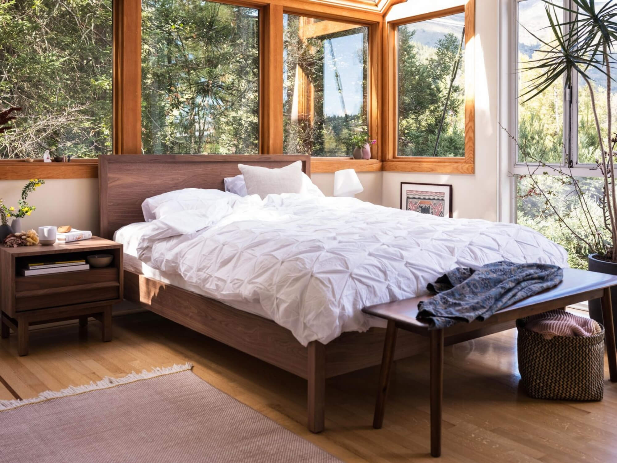 Oak platform bed in wood paneled modern bedroom