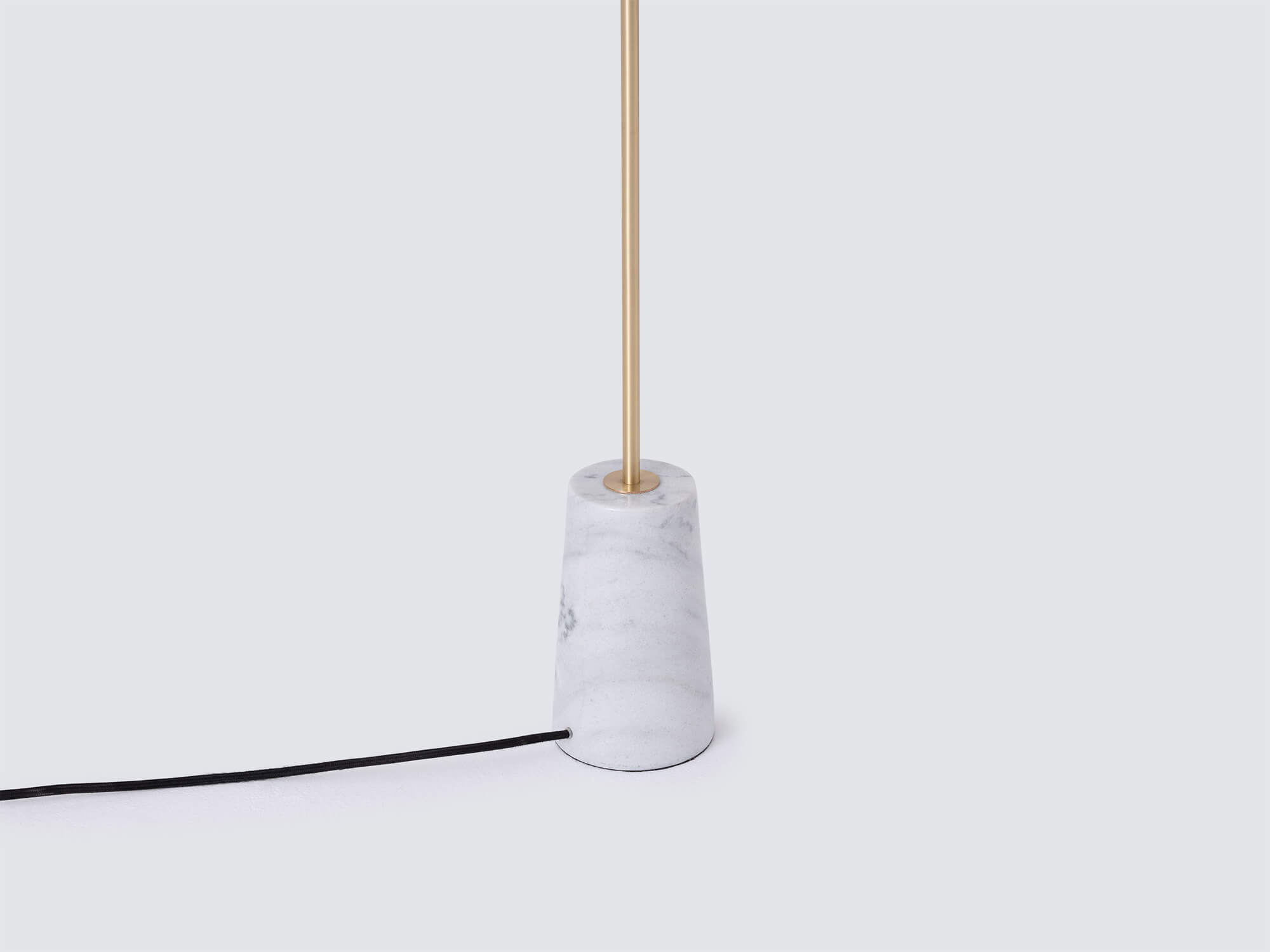Detail view of modern floor lamp with marble base