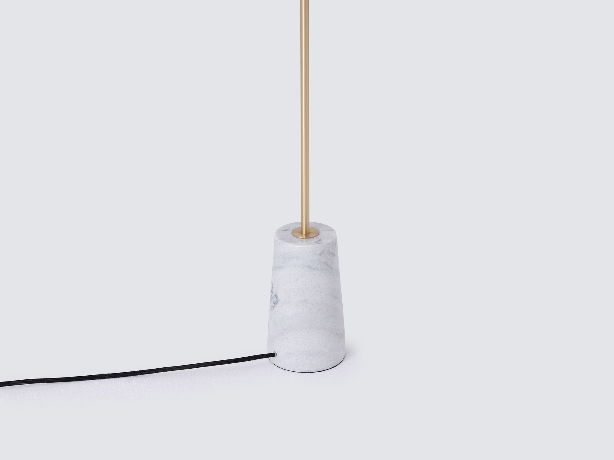 Detail view of modern floor lamp with marble base