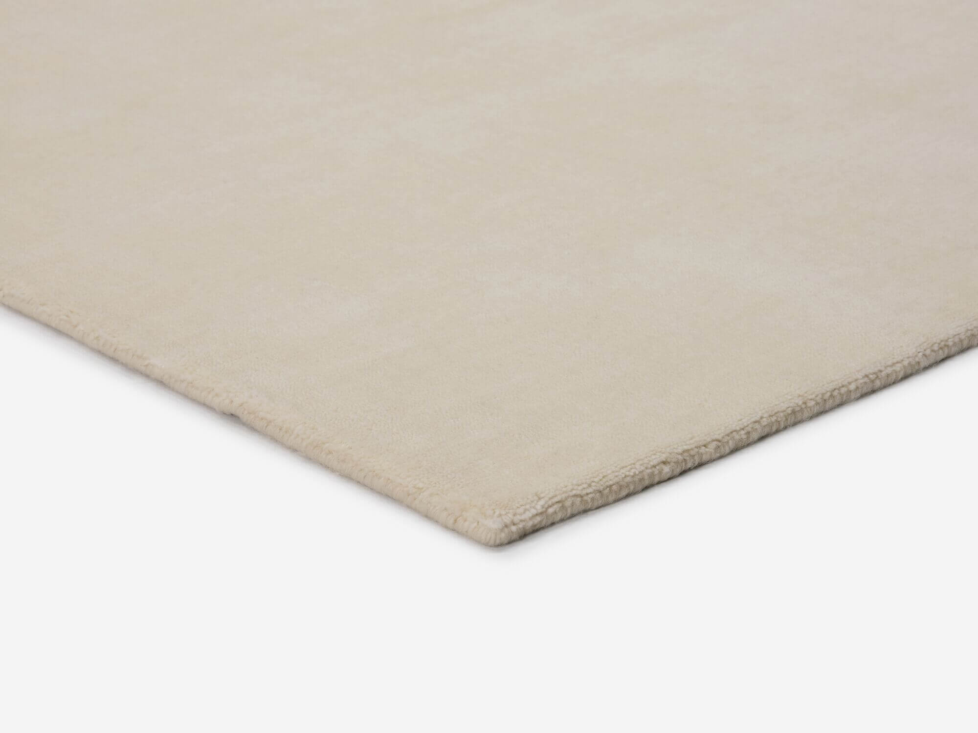 Durable cream area rug corner detail view