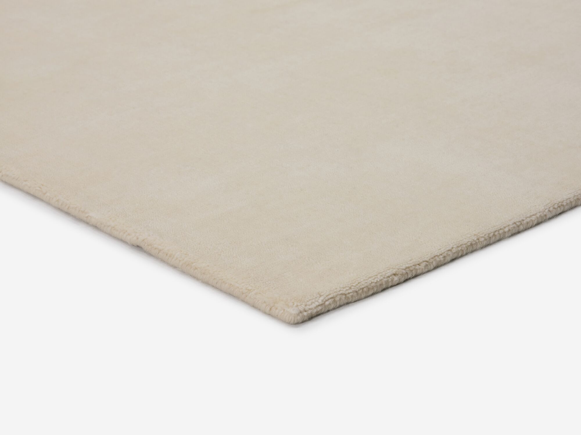 Durable cream area rug corner detail view