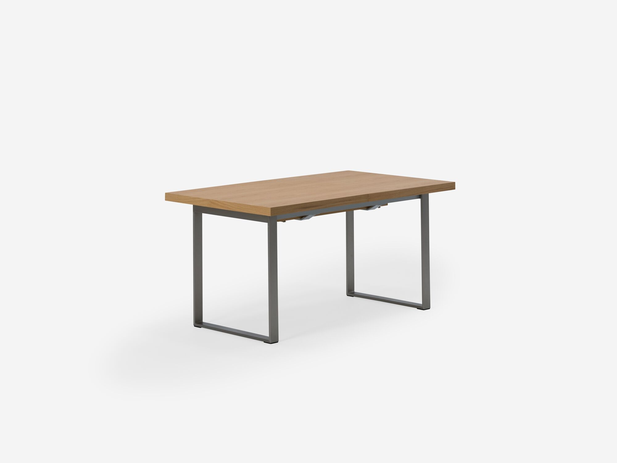 Corner view of expandable dining table with stainless steel legs and oak top