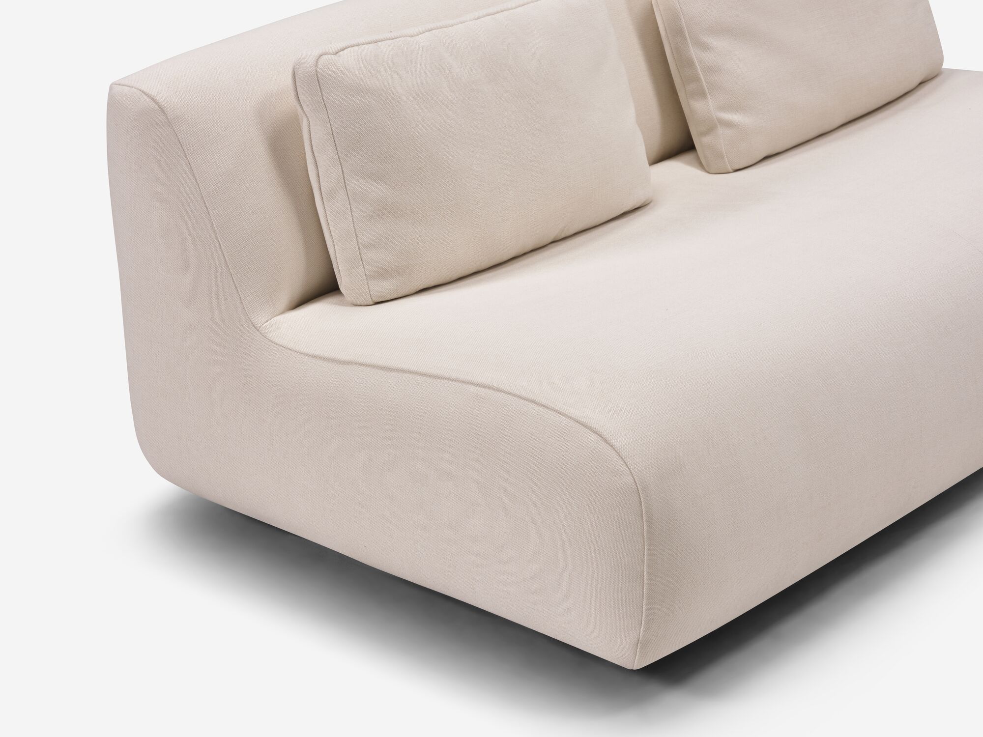 Beige armless loveseat detail view