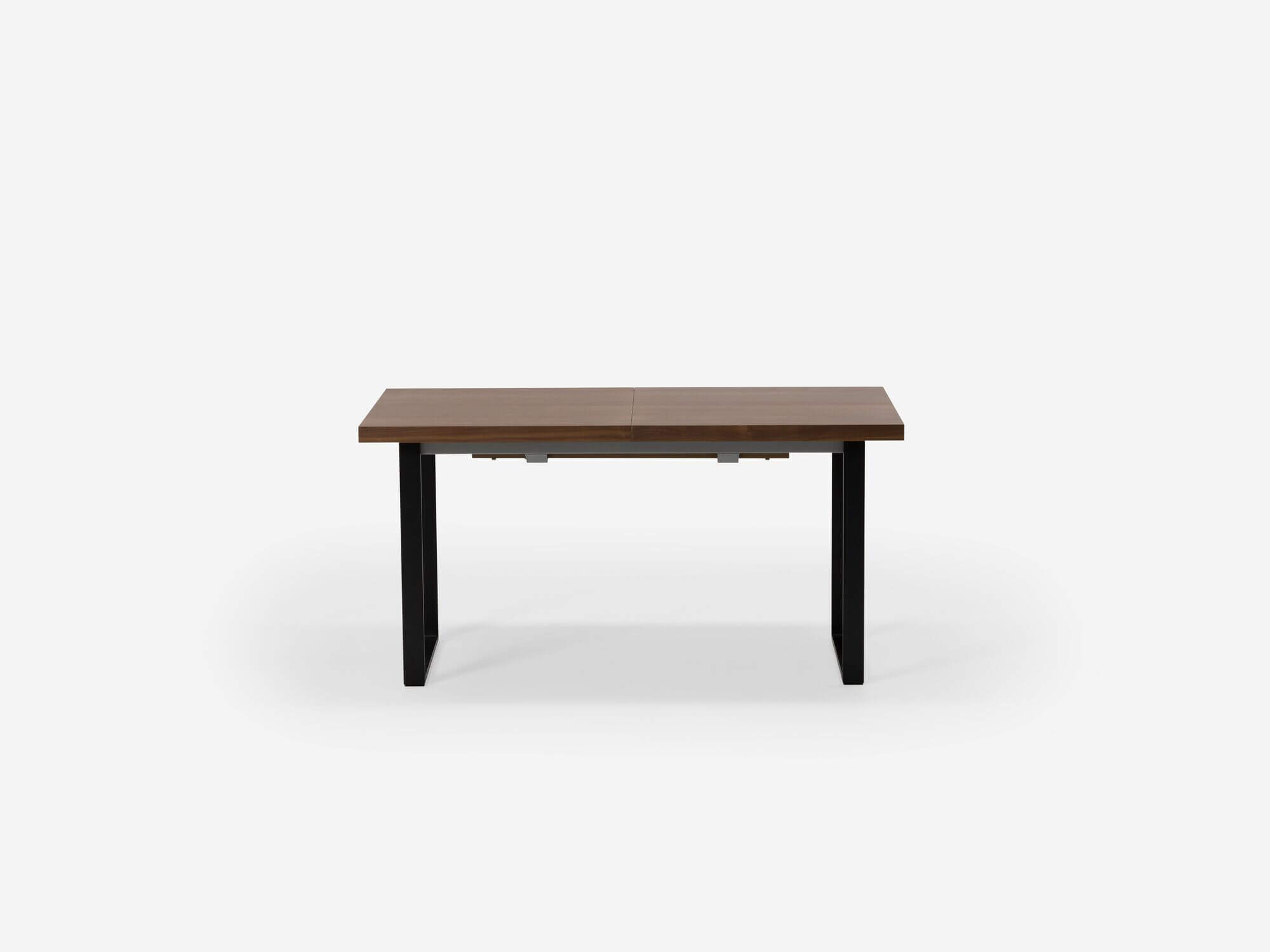Side view of expandable dining table with black legs and walnut top